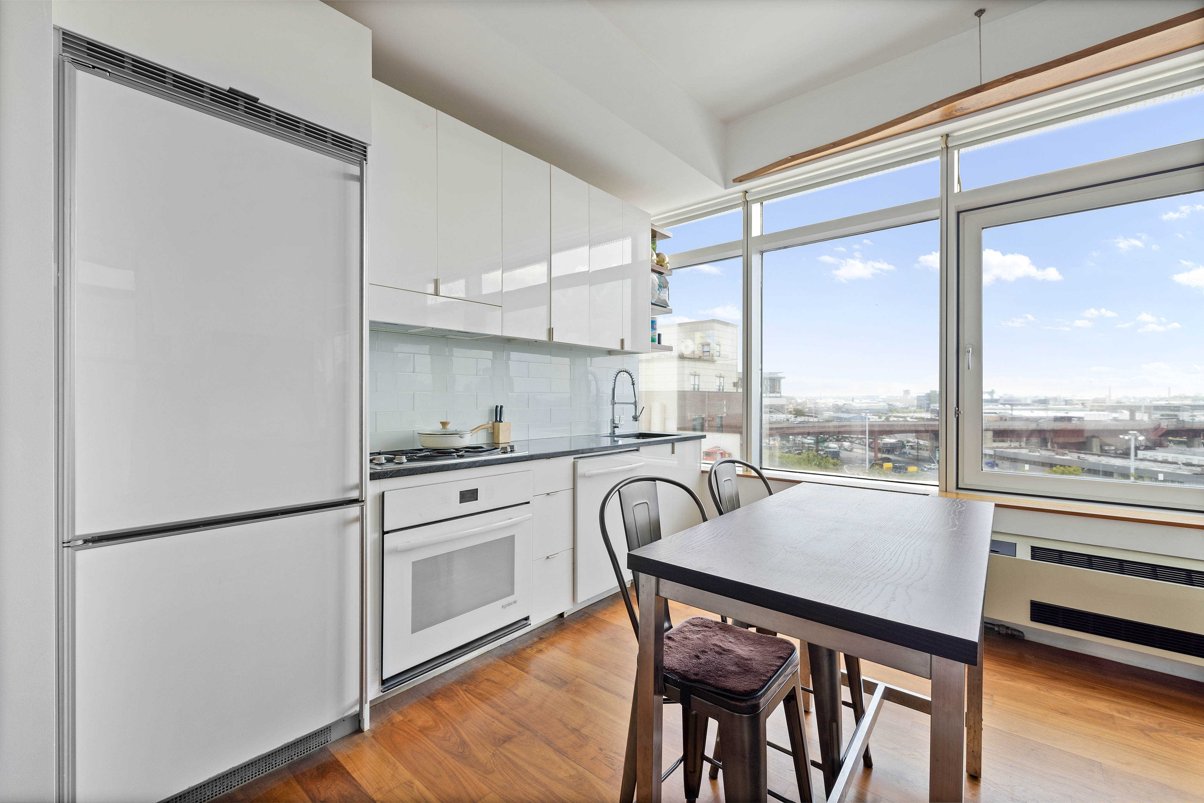 a kitchen with a table chairs refrigerator and cabinets