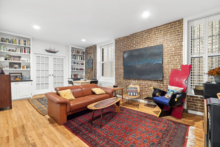 a living room with fireplace furniture and a flat screen tv