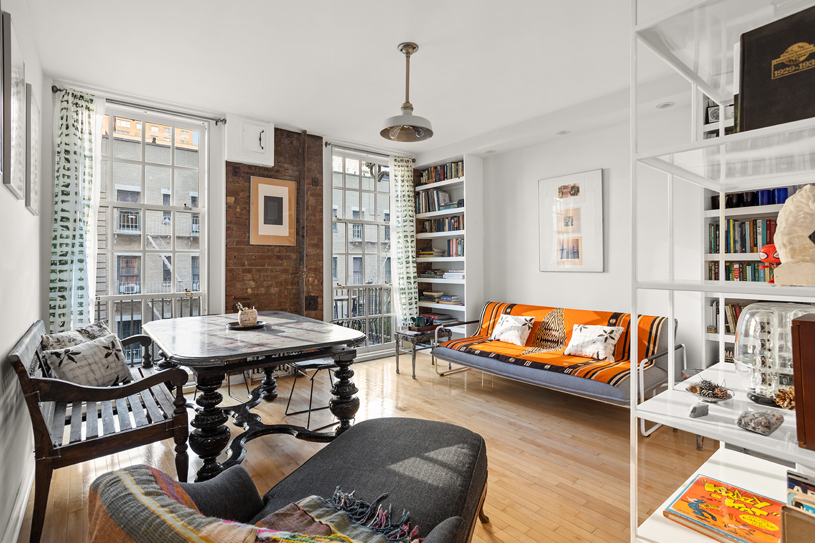 a living room with furniture and a book shelf