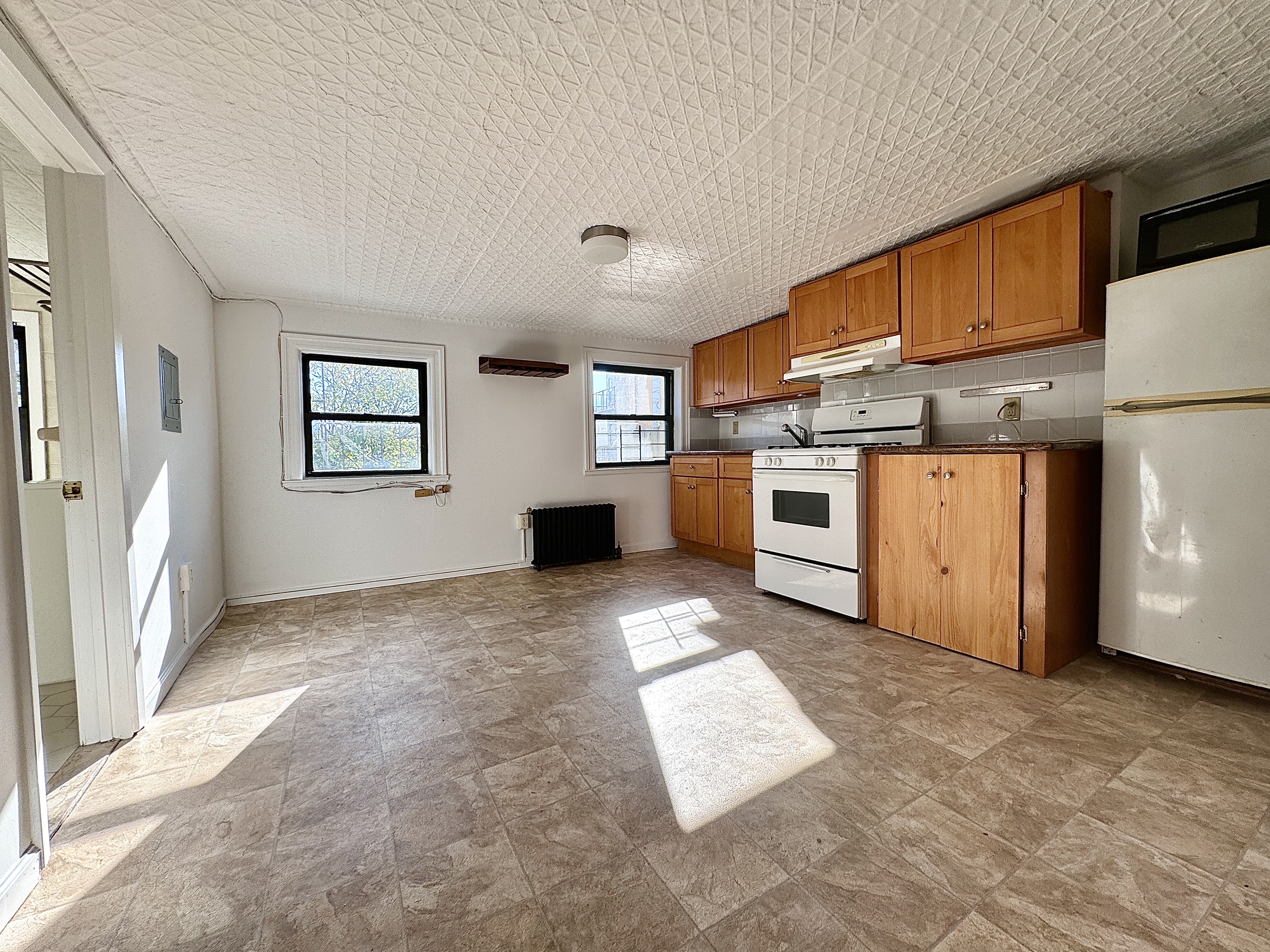 a view of a kitchen with a sink stove cabinets and a kitchen