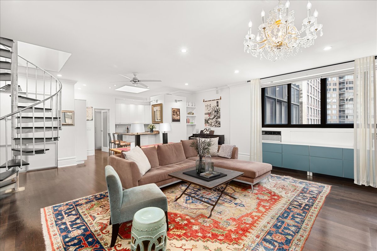 a living room with furniture and a chandelier