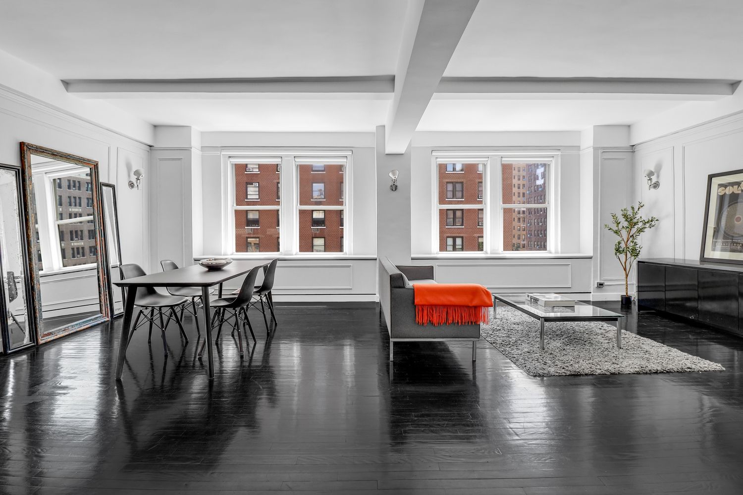 a living room with furniture and wooden floor