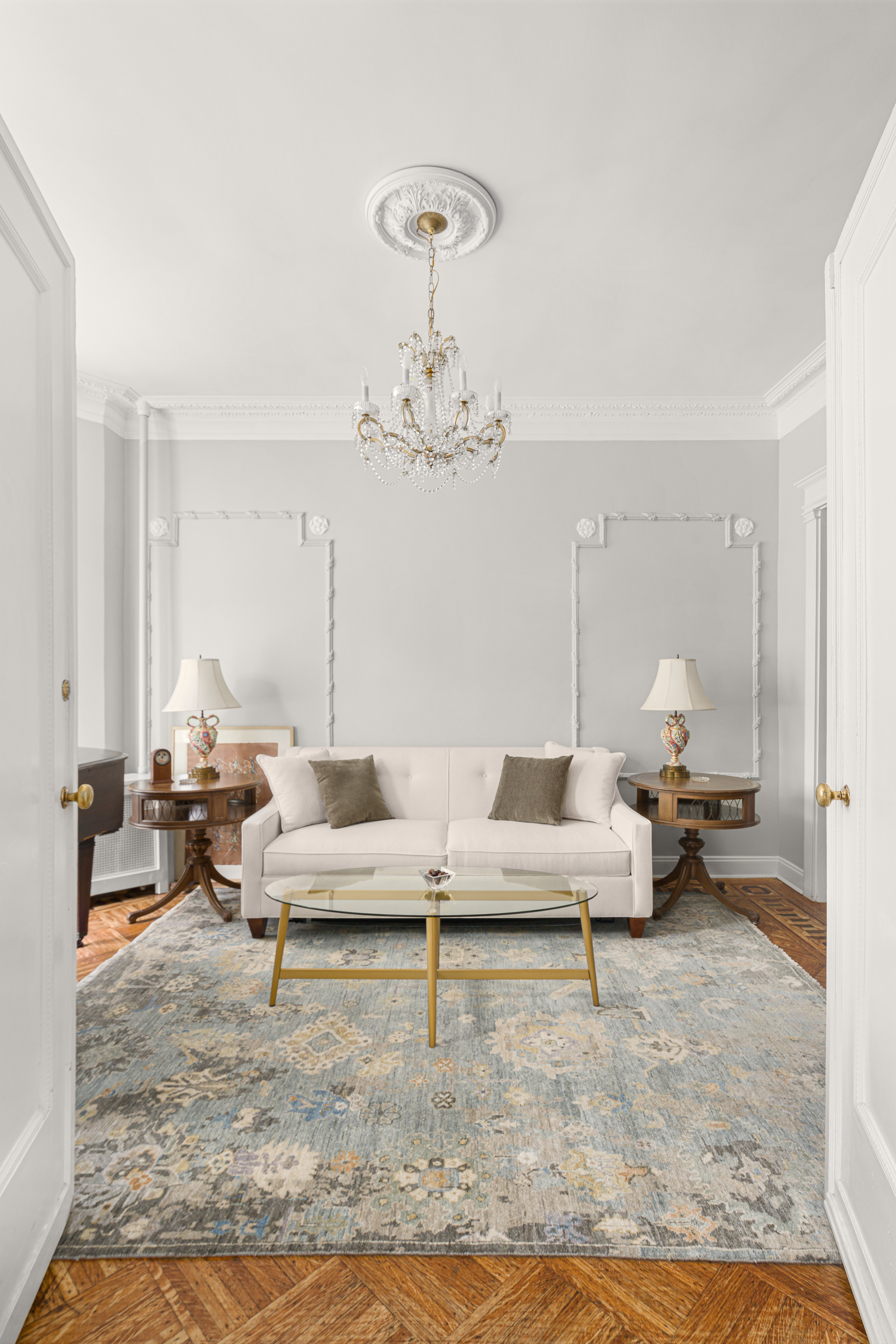 a living room with furniture and a chandelier