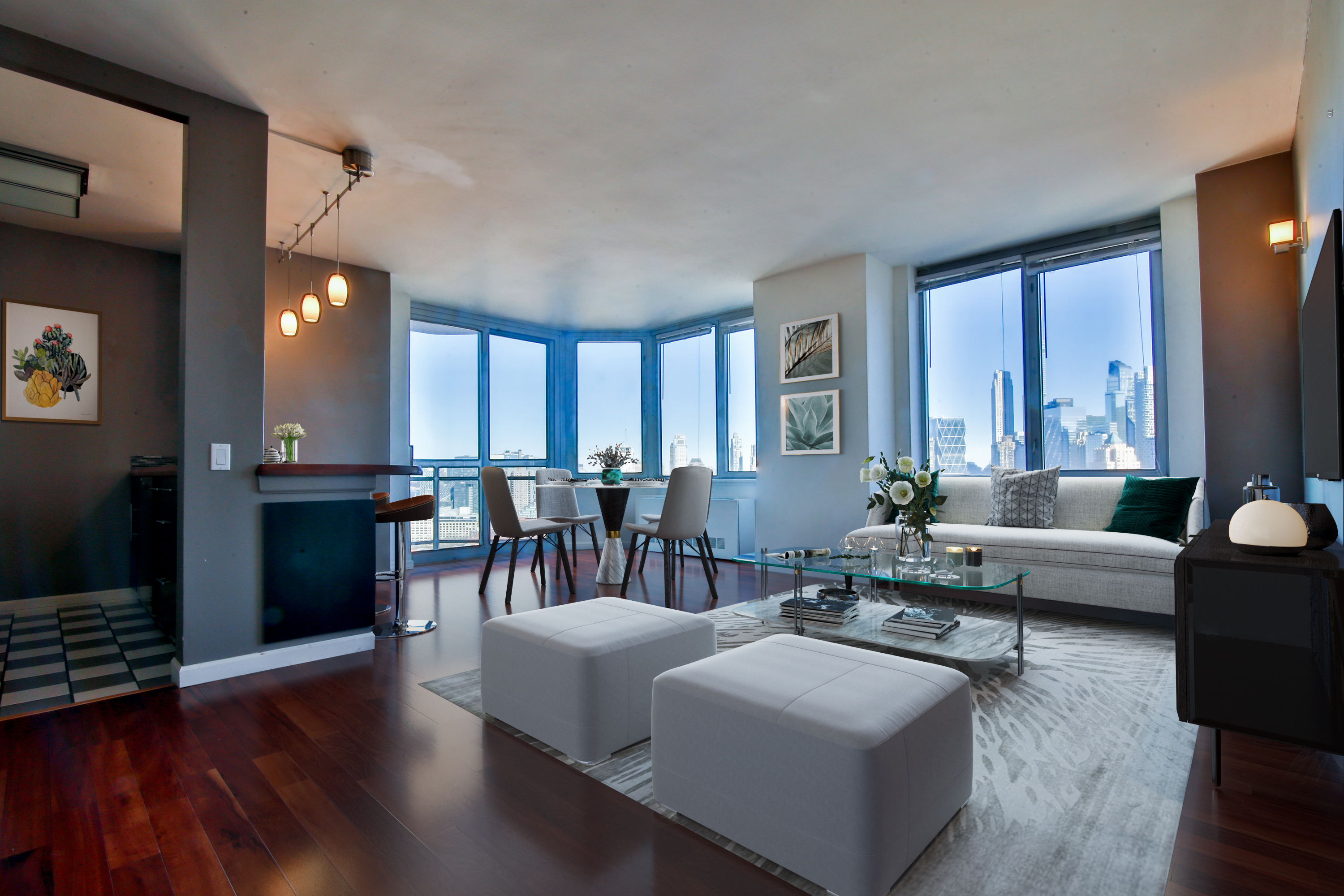 a living room with furniture and a wooden floor