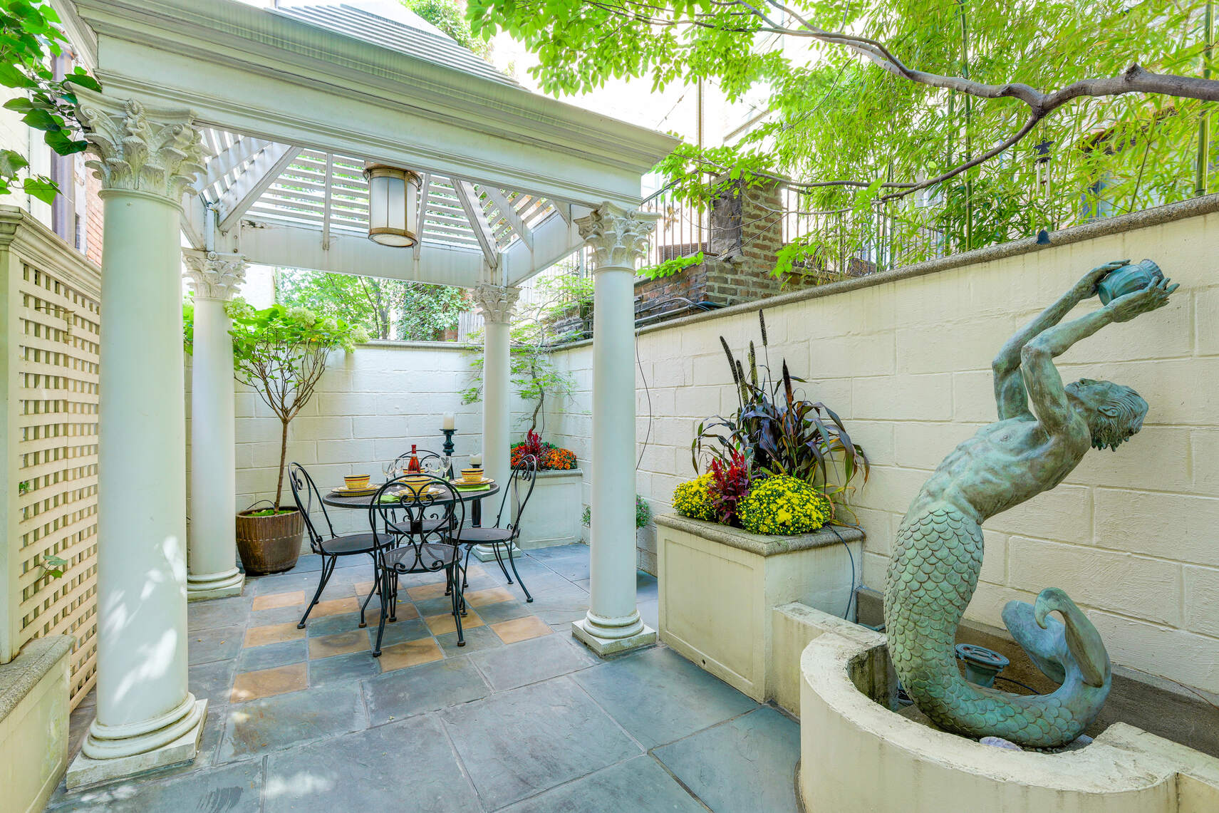 a view of a chair and table in backyard of the house