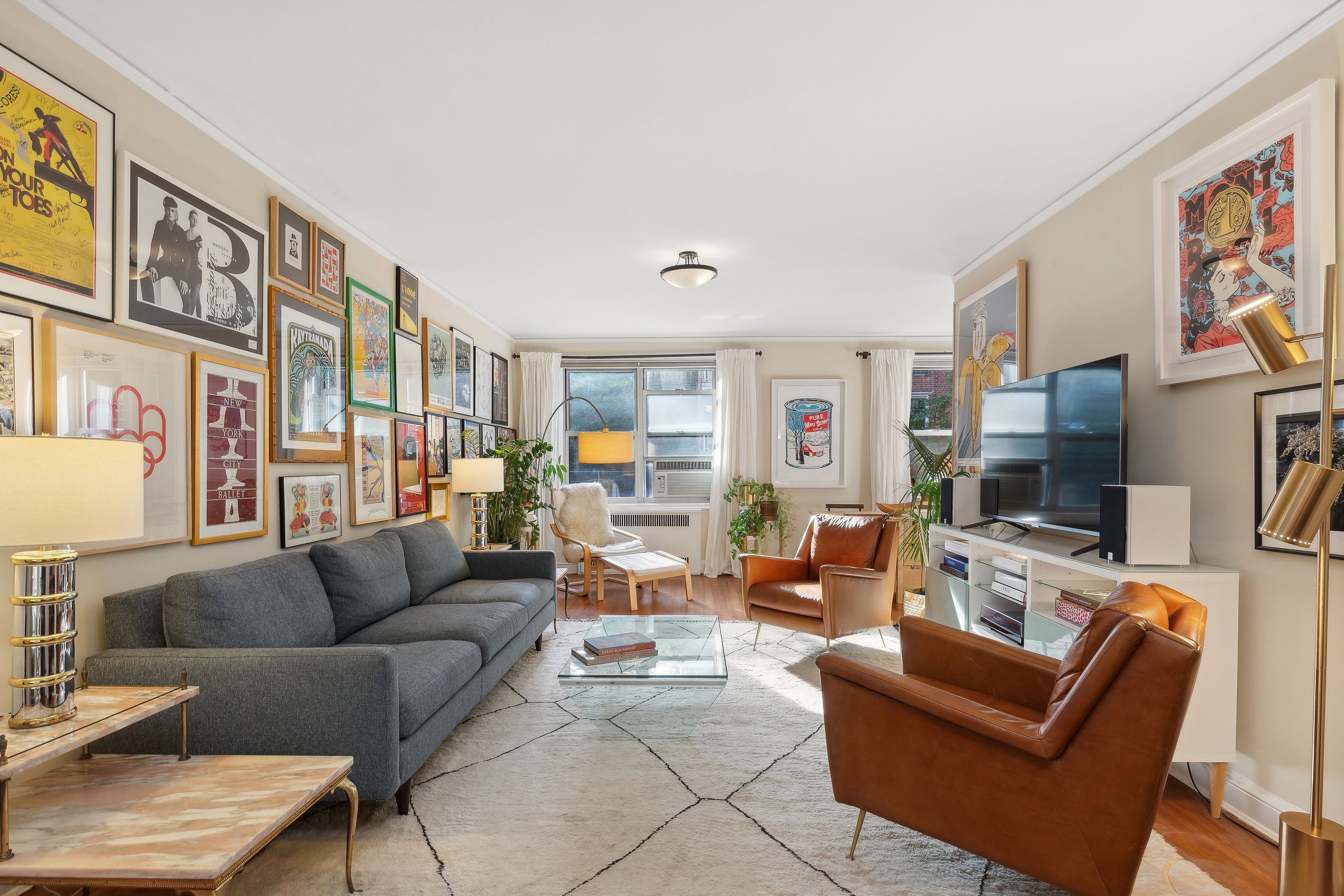 a living room with furniture a flat screen tv and a fireplace