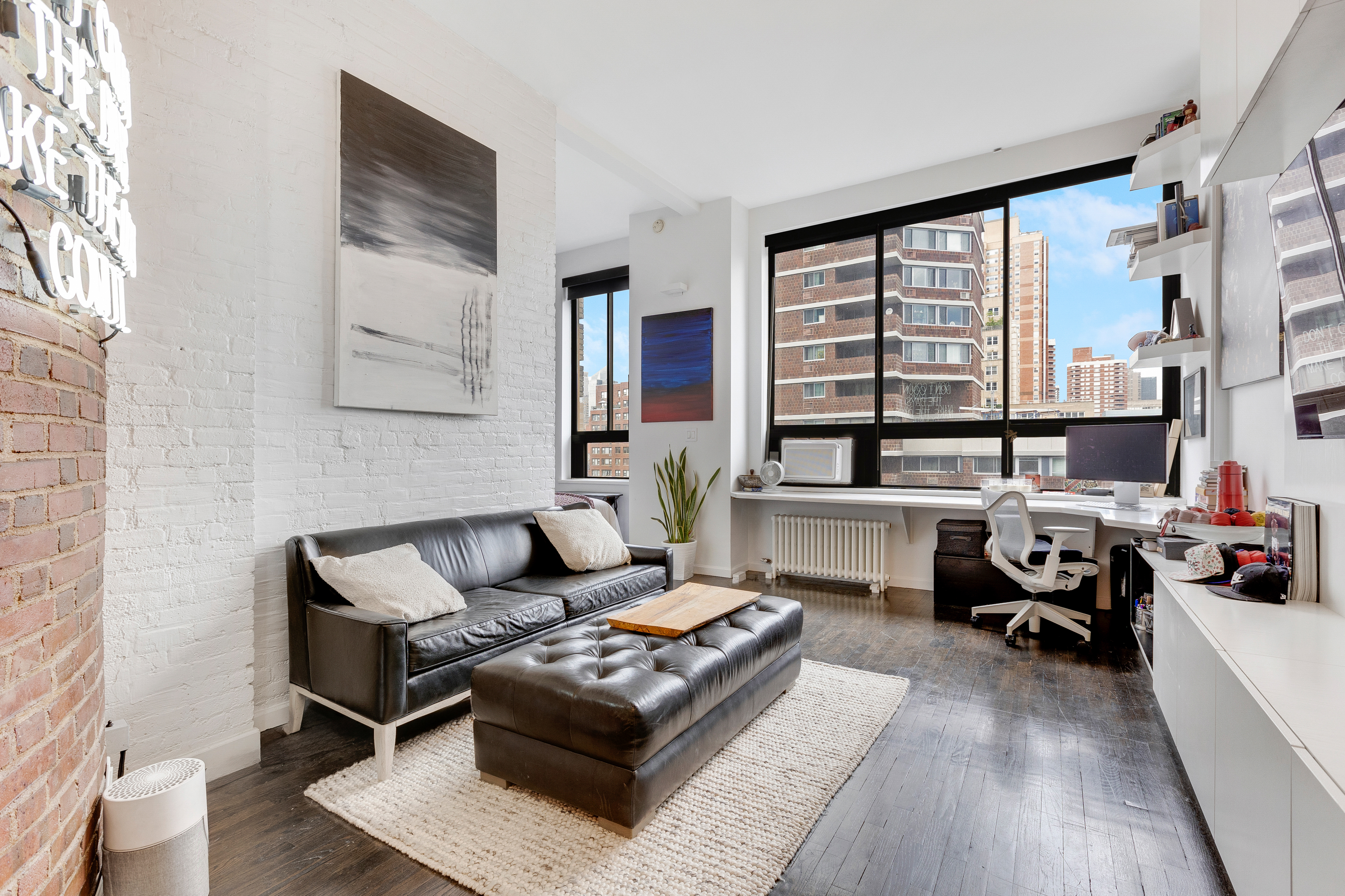 a living room with furniture and large windows