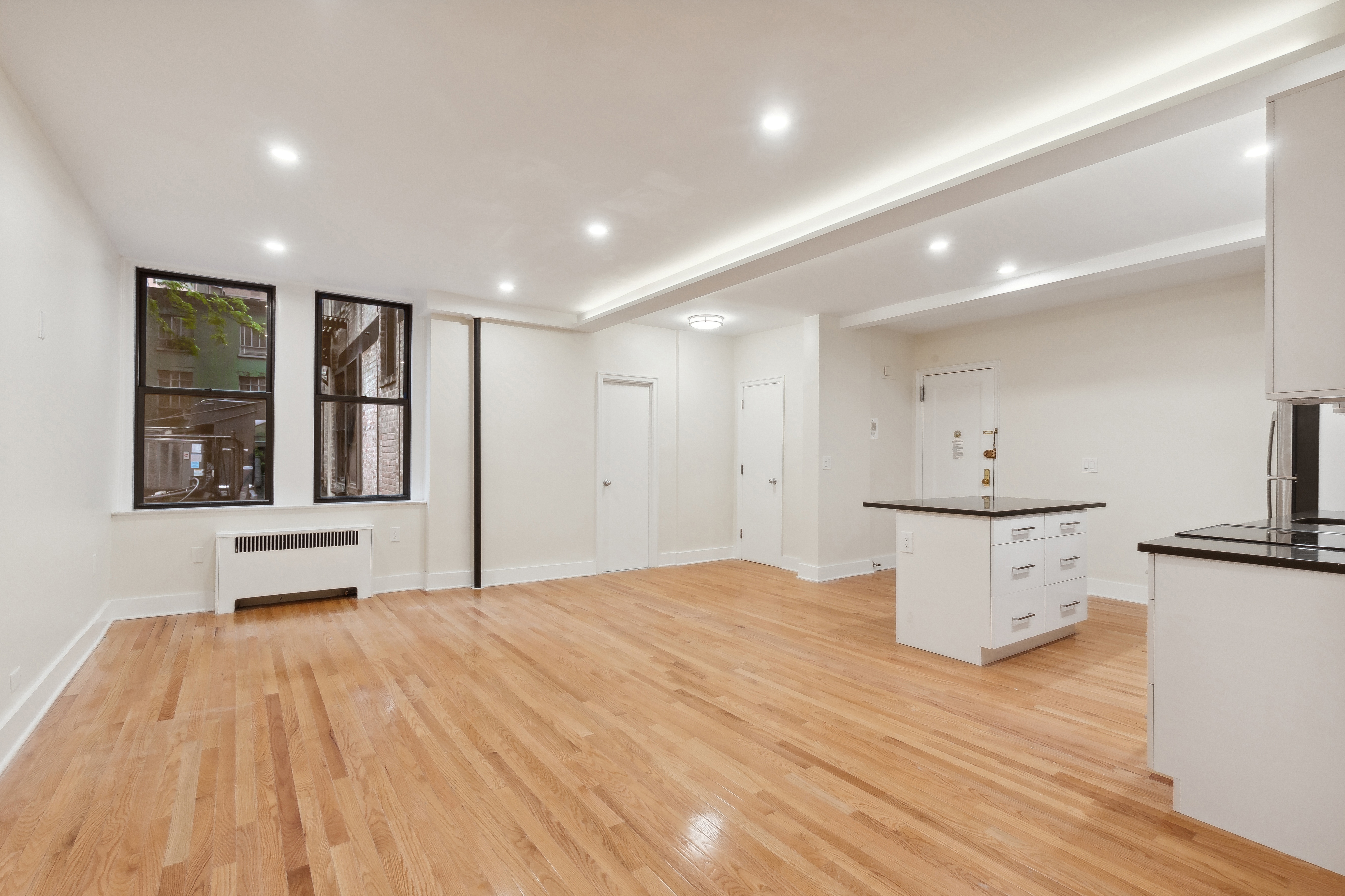 a view of kitchen with furniture and wooden floor