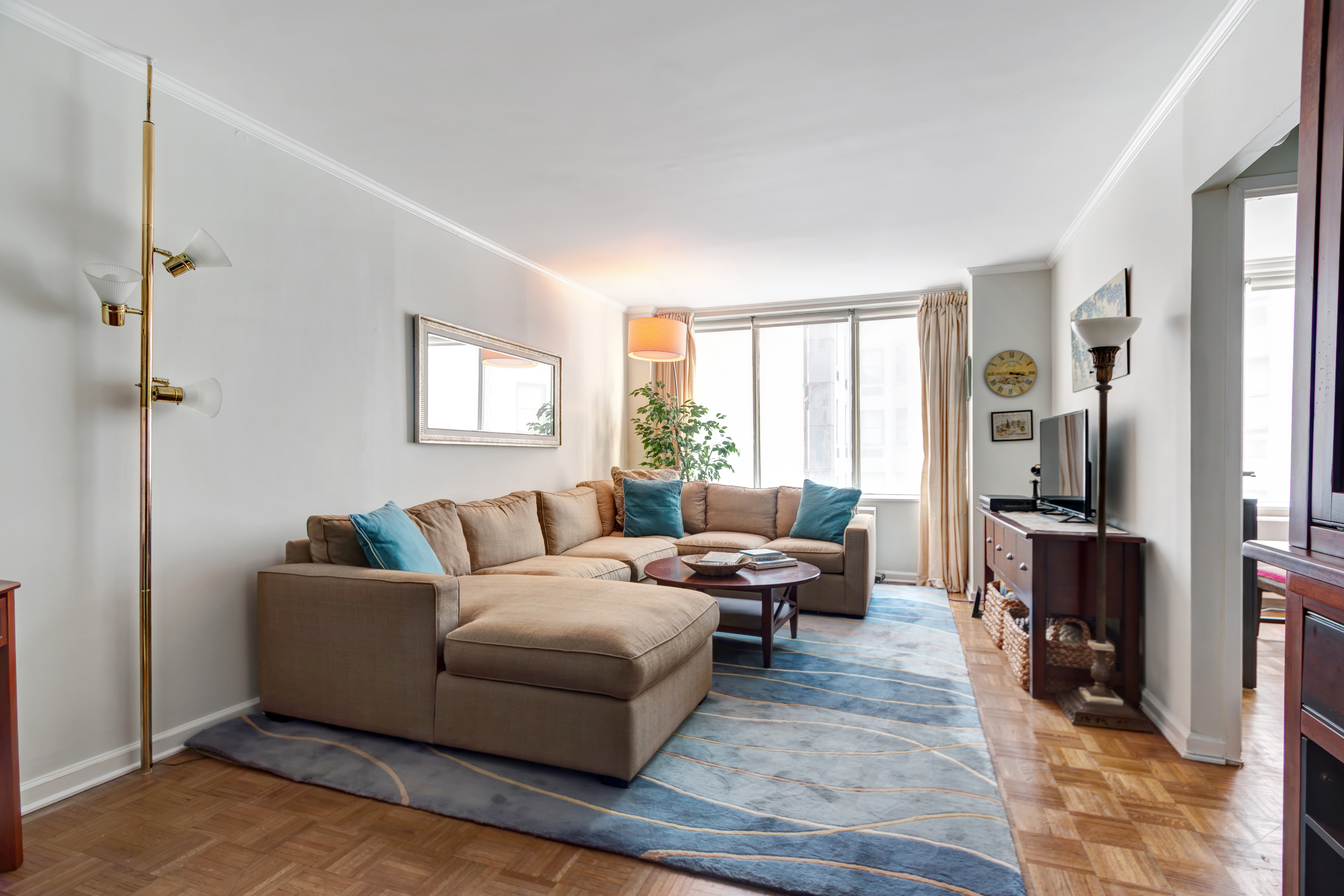 a living room with furniture window and a flat screen tv