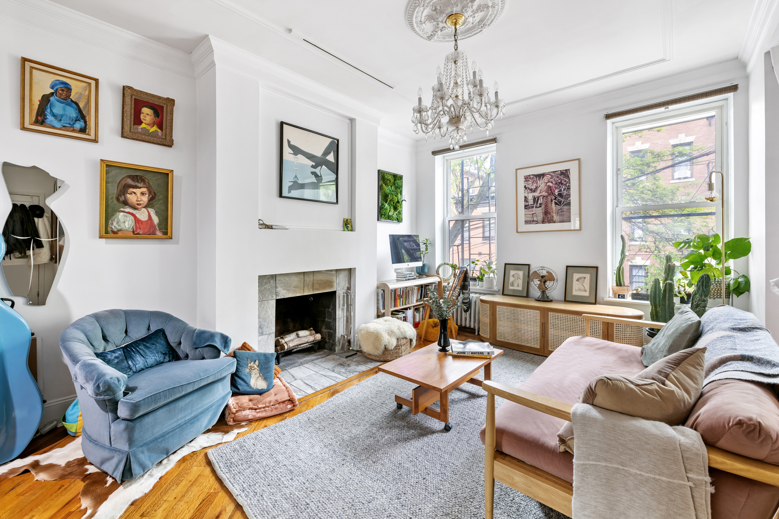 a living room with furniture a chandelier and a fireplace