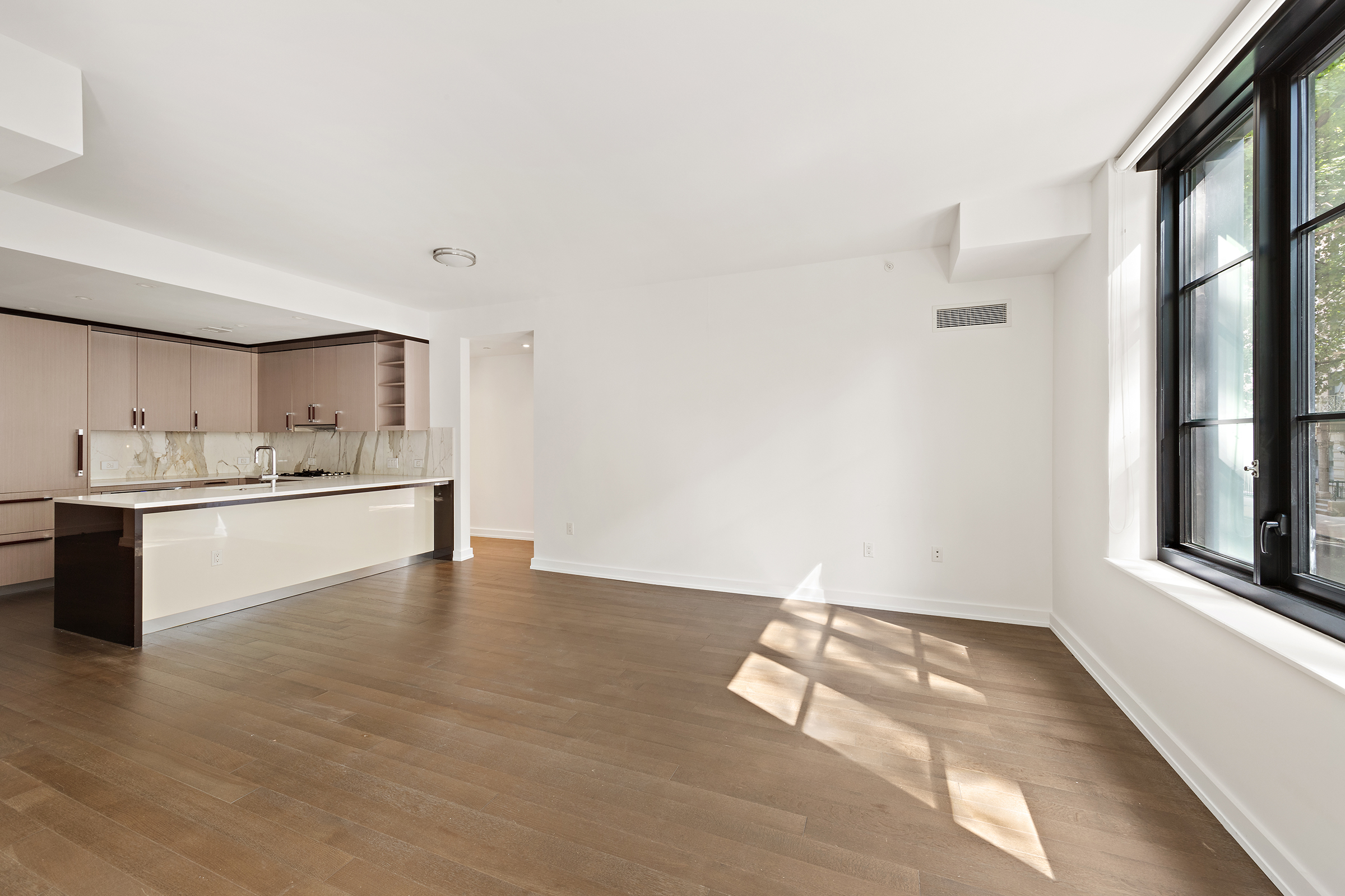 a view of kitchen with wooden floor and electronic appliances