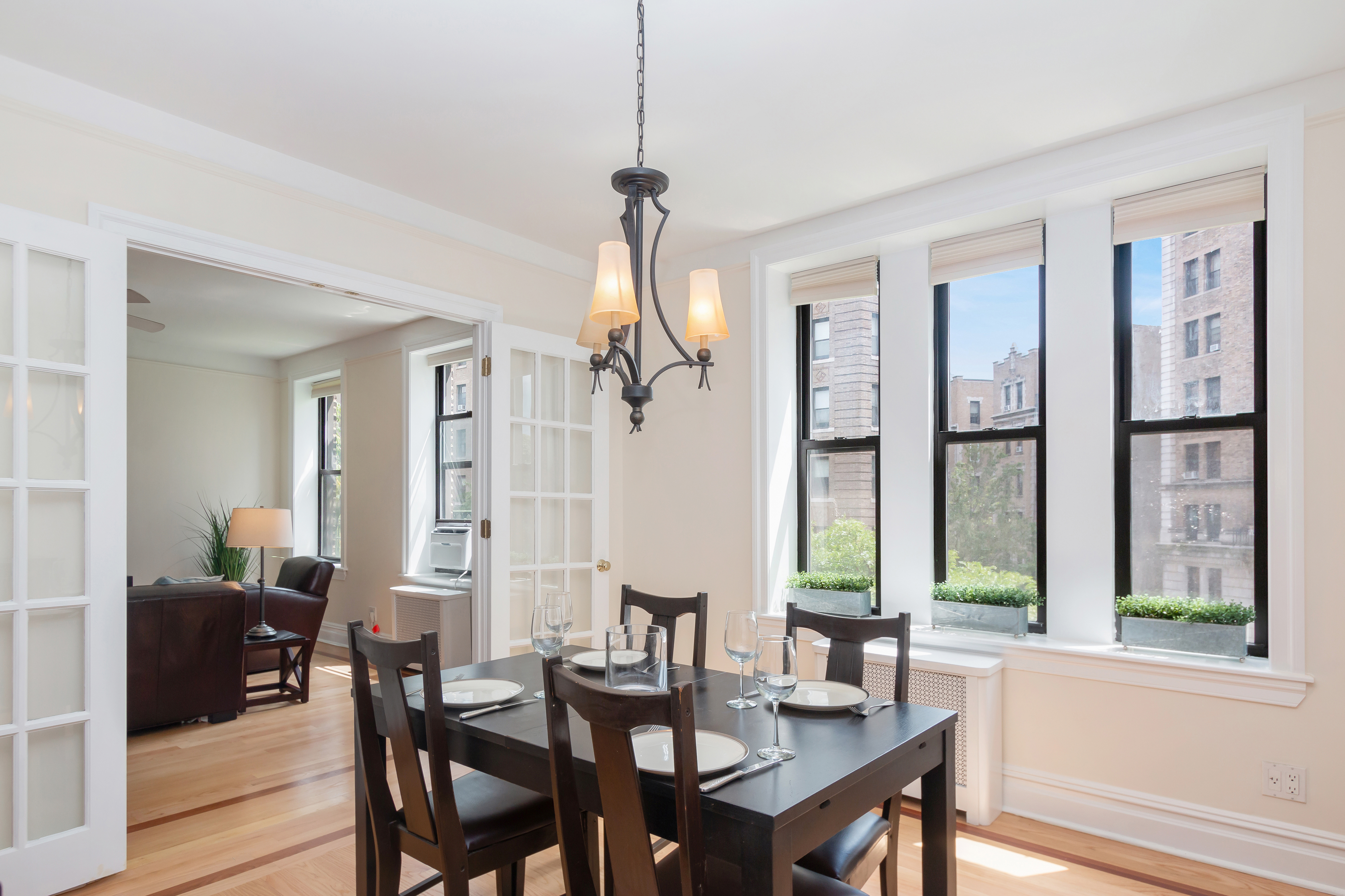 a view of a a dining room with furniture window and wooden floor