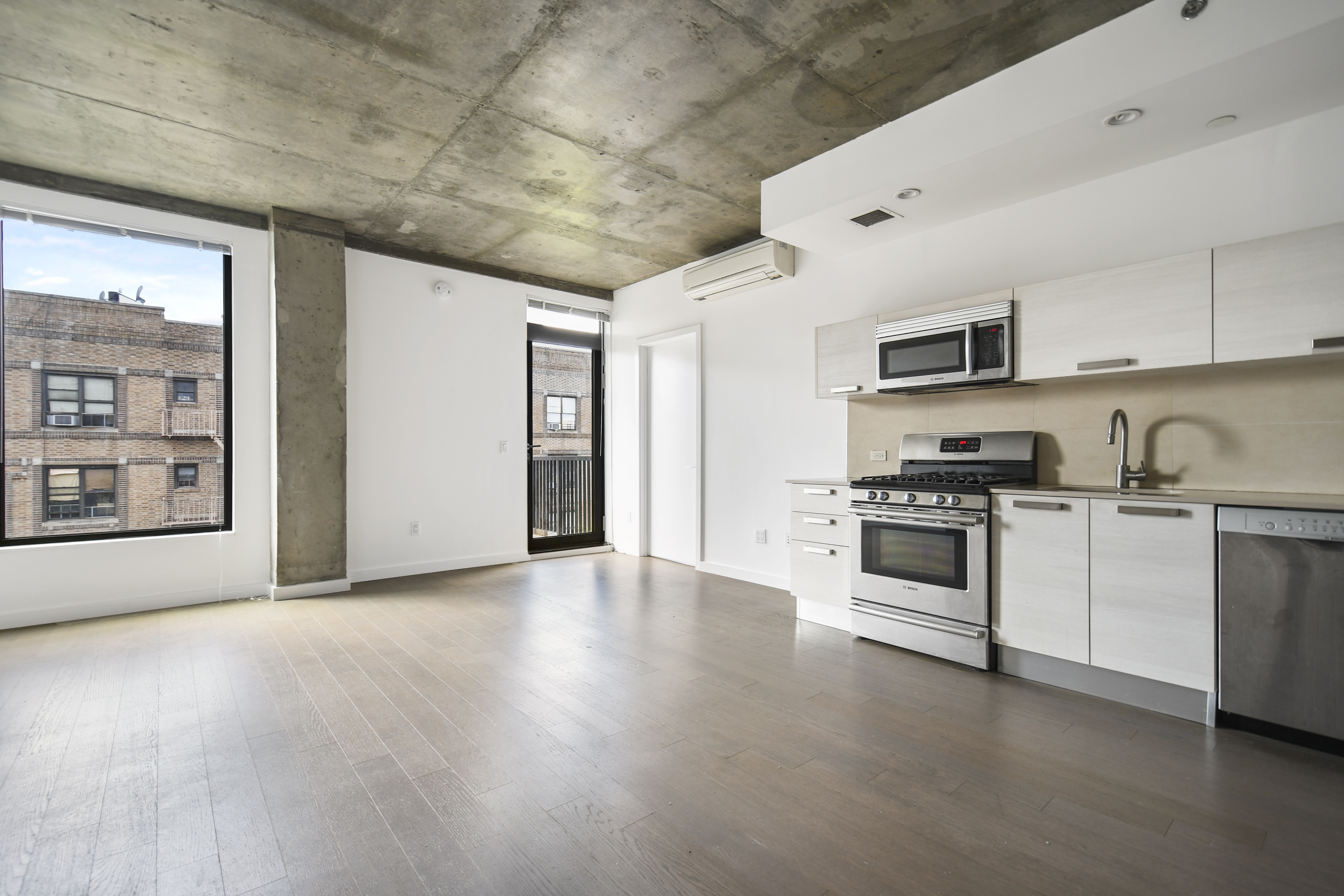 a kitchen with granite countertop a sink and steel appliances