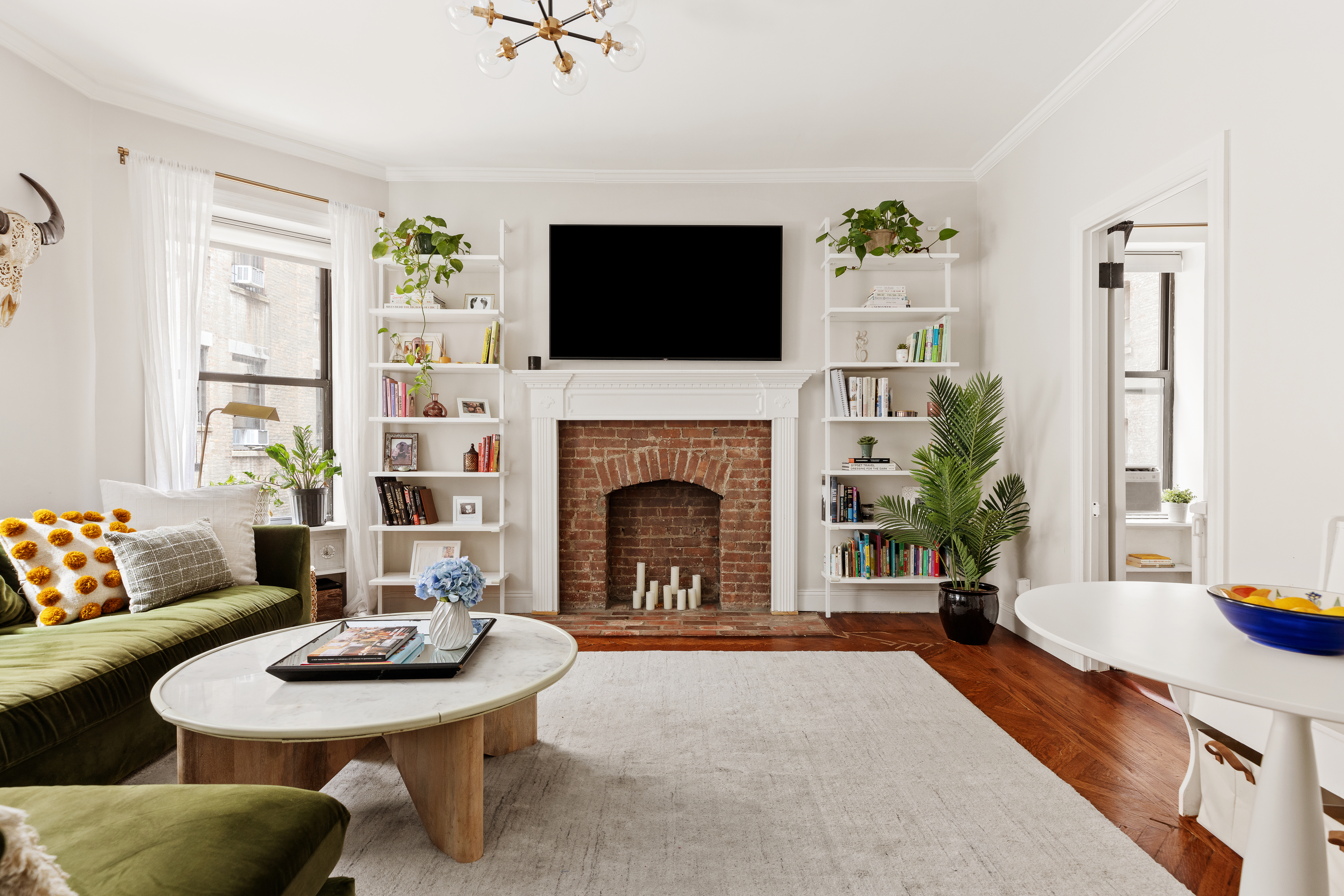 a living room with furniture a flat screen tv and a fireplace