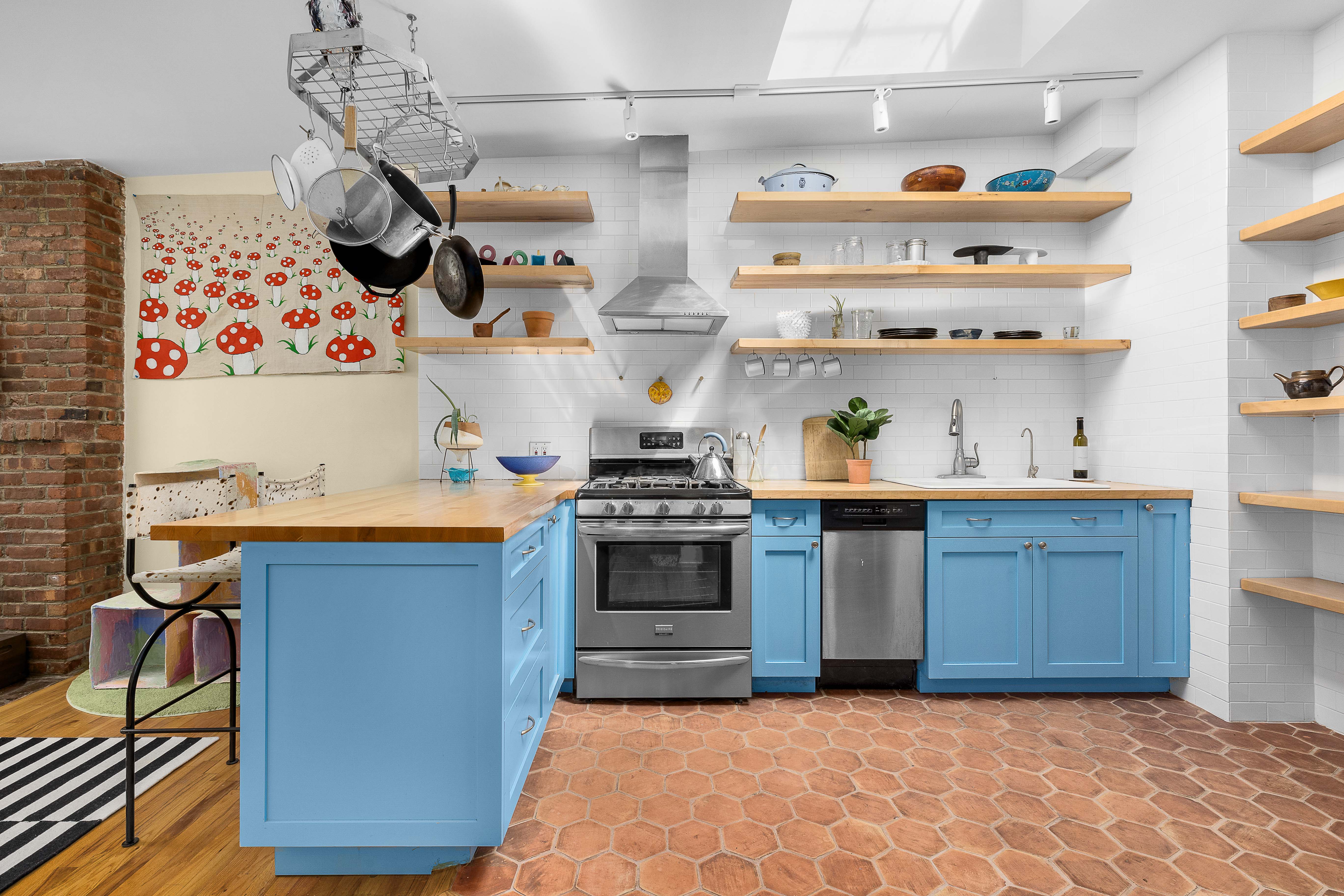 a kitchen with stainless steel appliances granite countertop a stove and cabinets