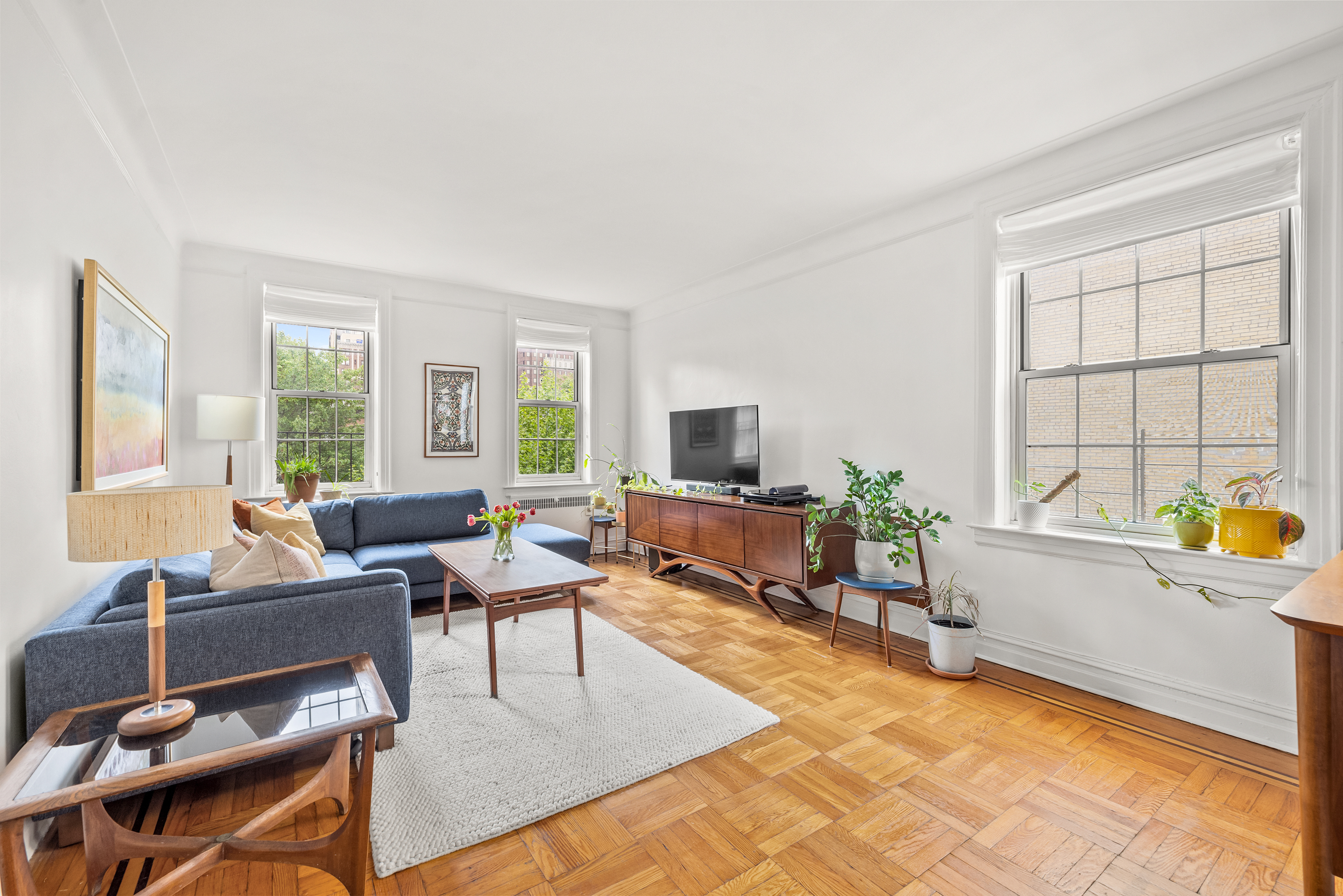 a living room with furniture large window and flat screen tv