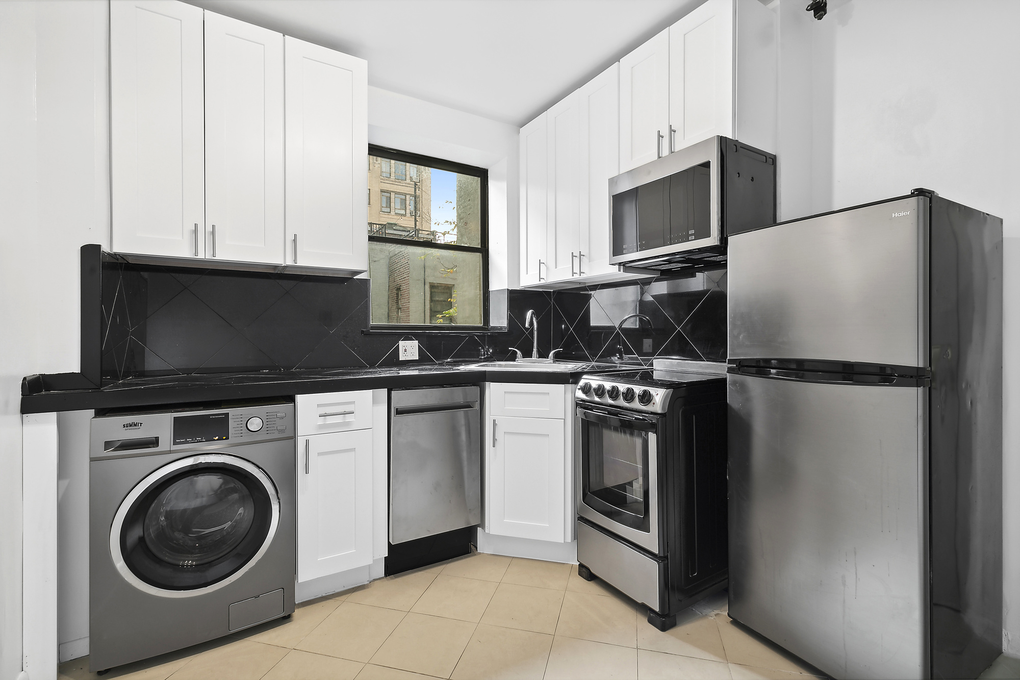 a kitchen with stainless steel appliances a refrigerator stove and microwave