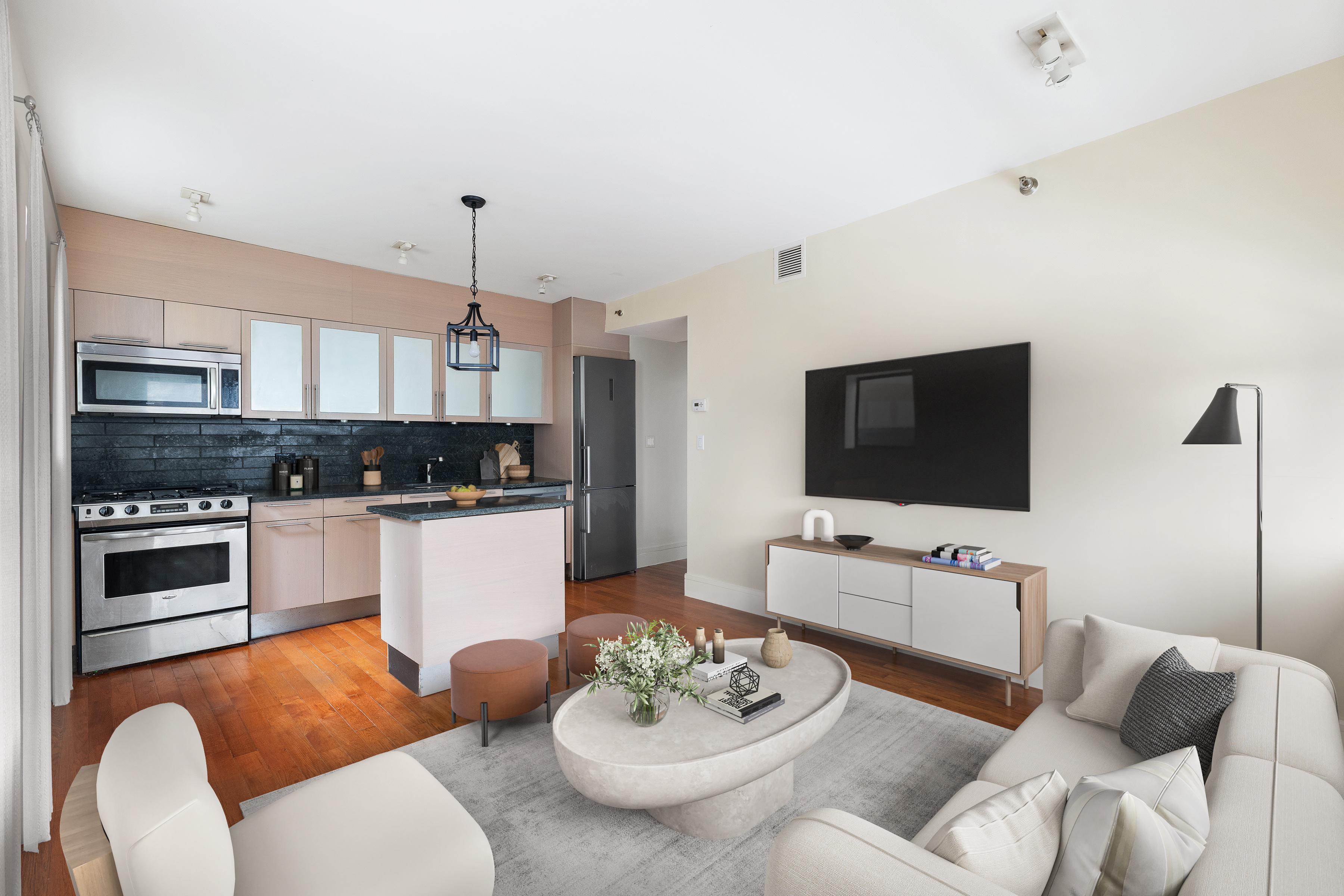 a living room with furniture kitchen and a flat screen tv