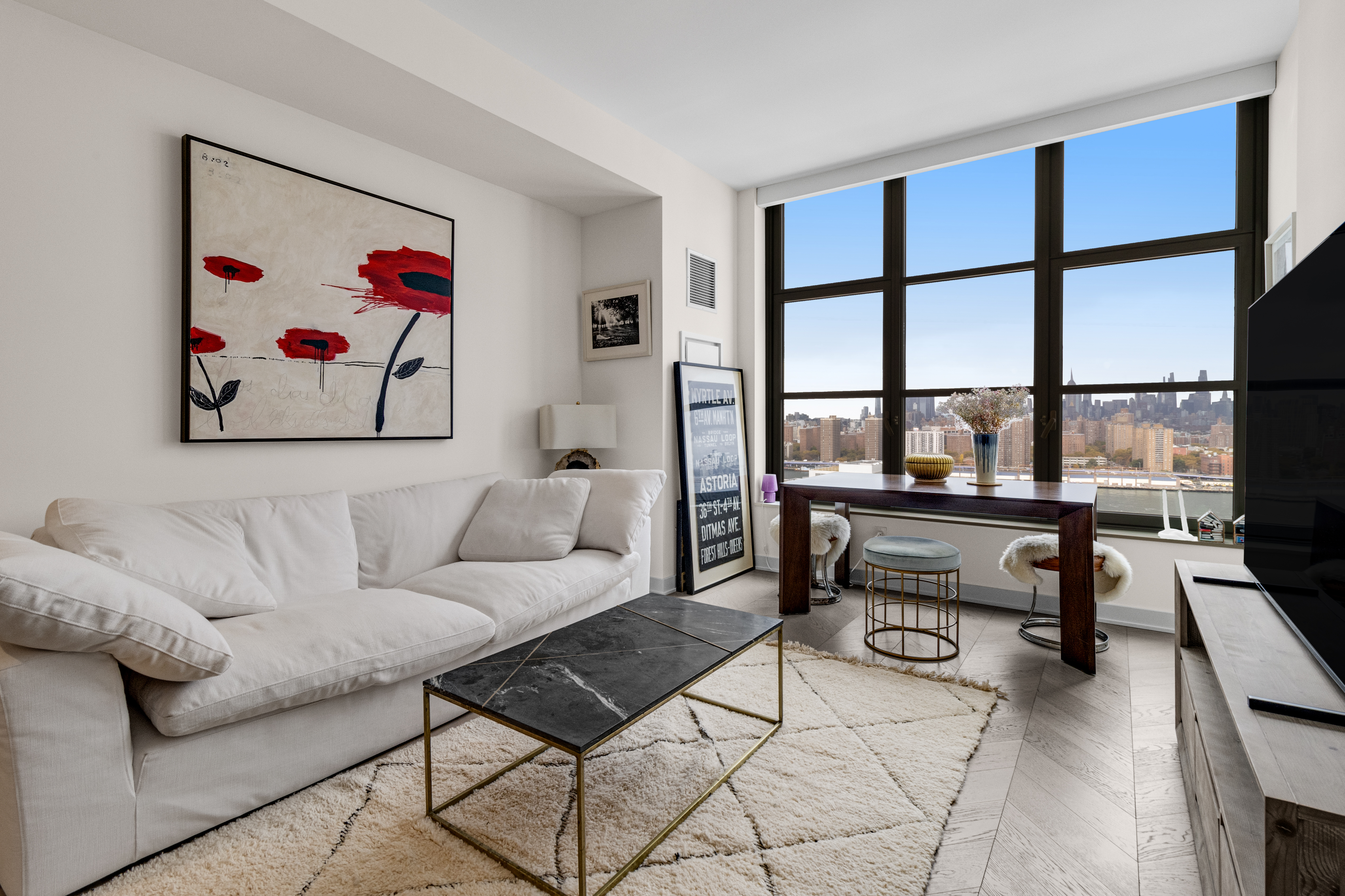 a living room with furniture a rug and a painting on the wall