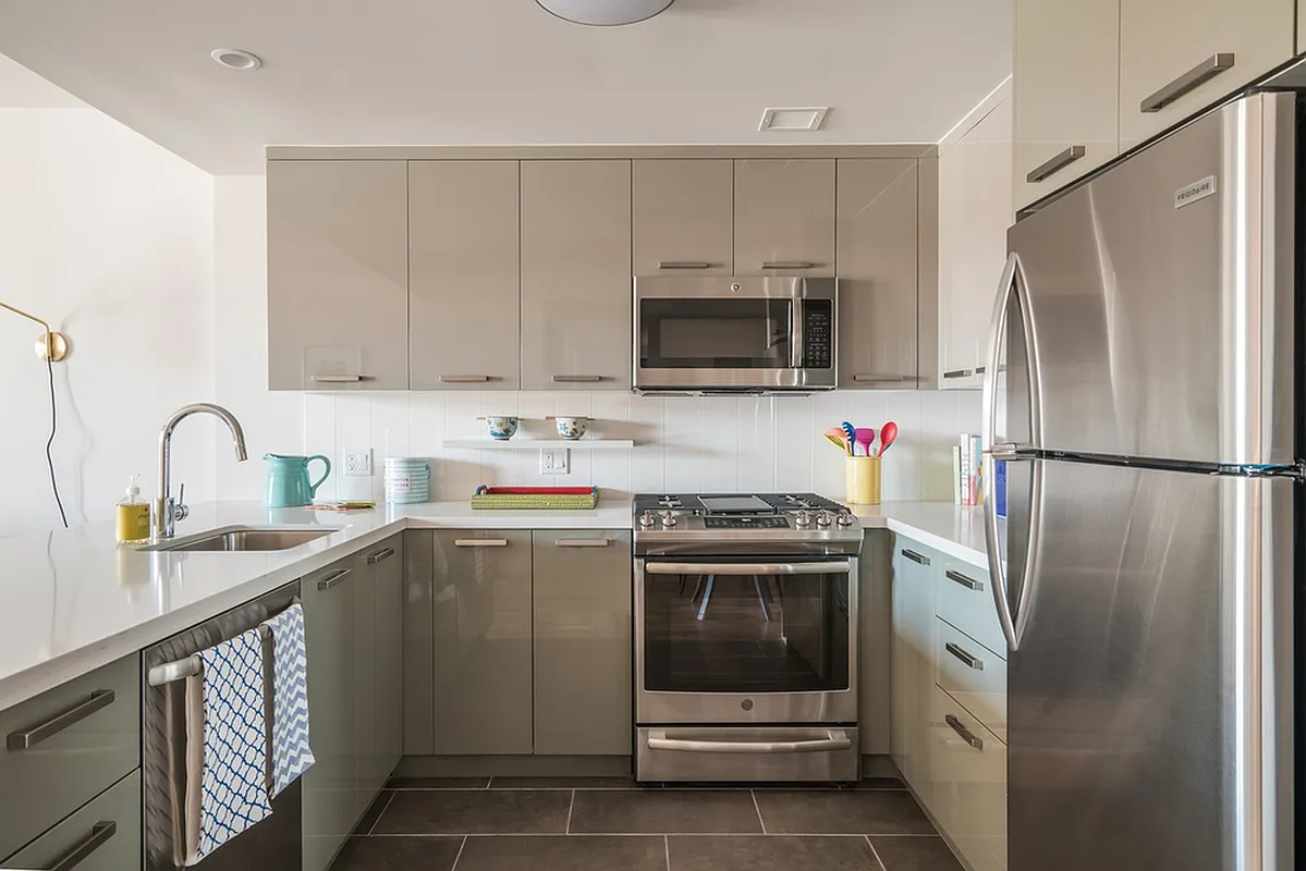 a kitchen with stainless steel appliances granite countertop a refrigerator sink and stove