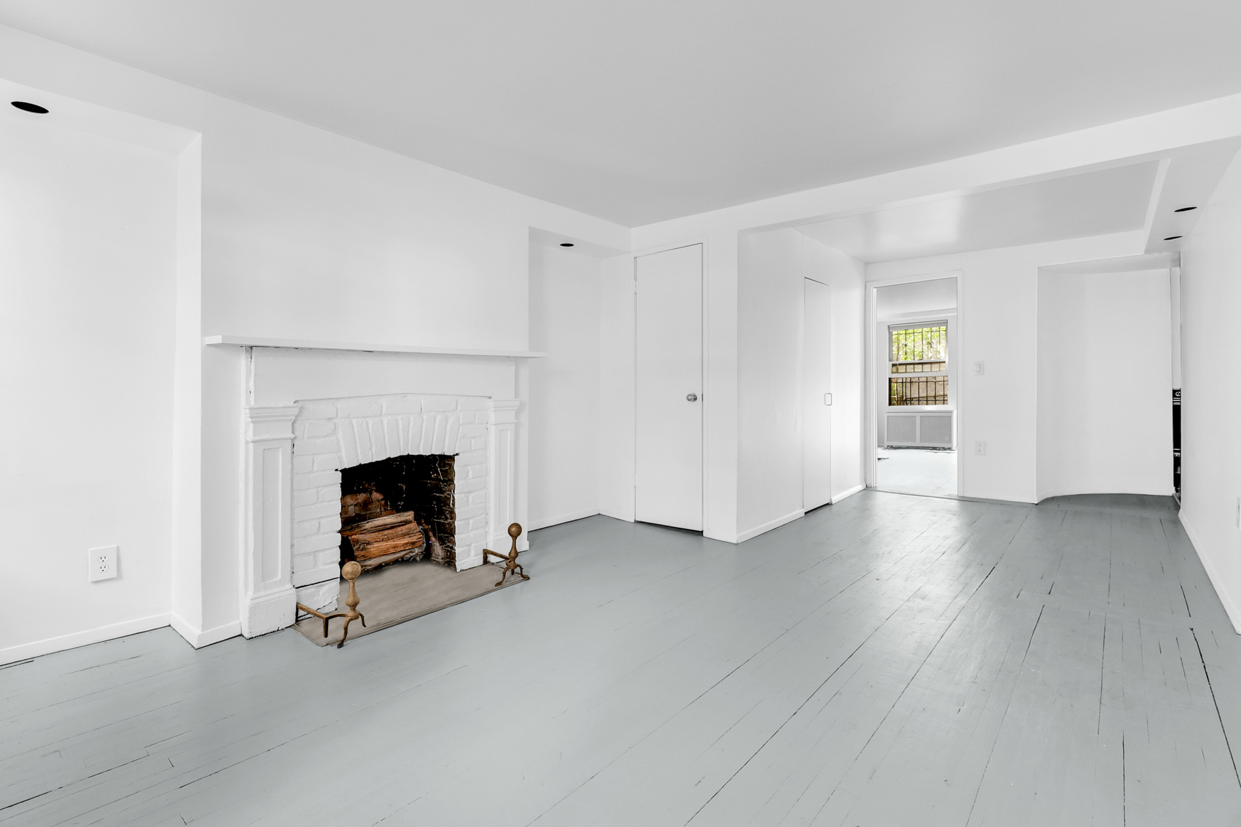 a view of a livingroom with a fireplace and window