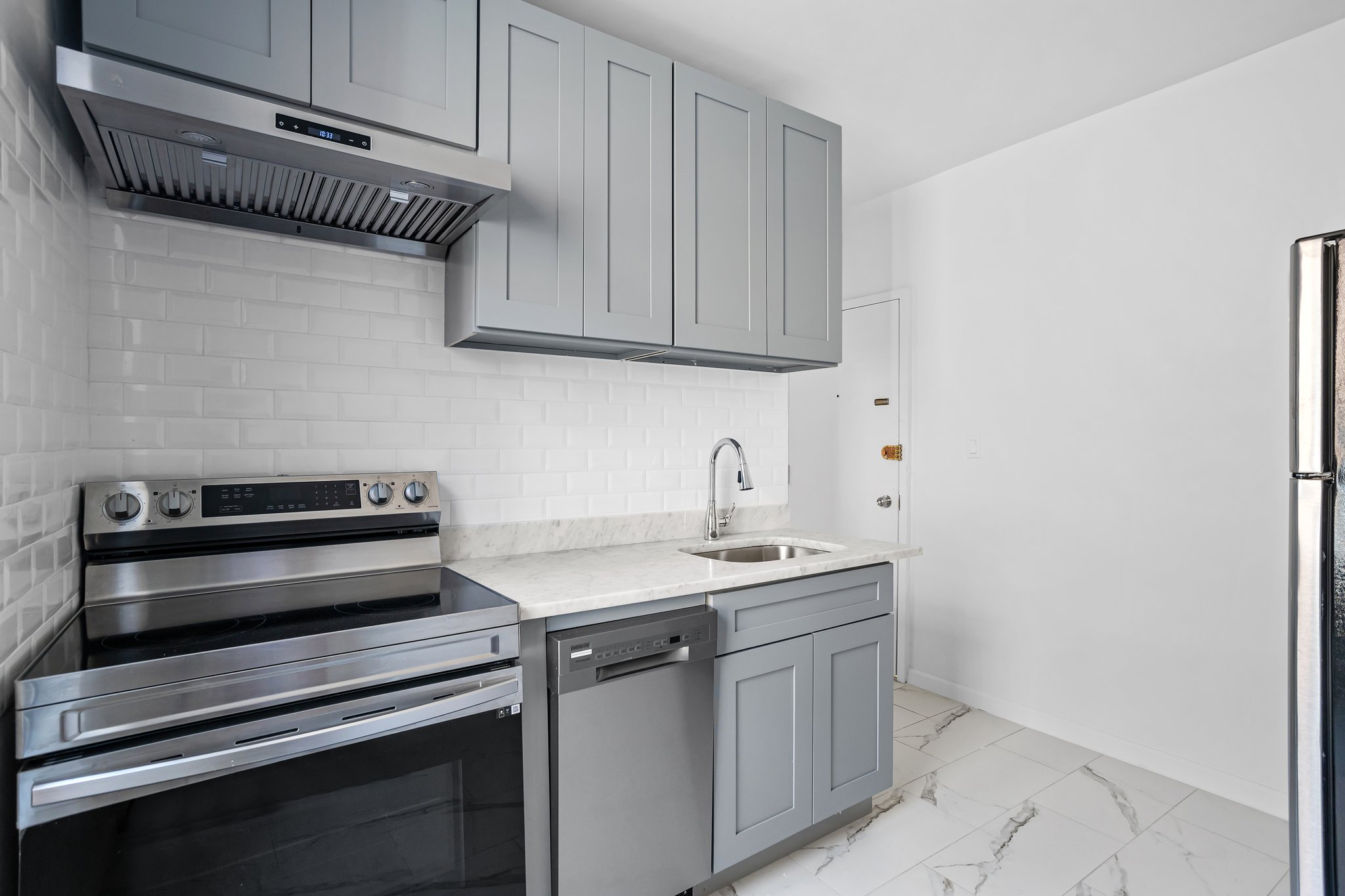 a kitchen with stainless steel appliances a sink stove and cabinets