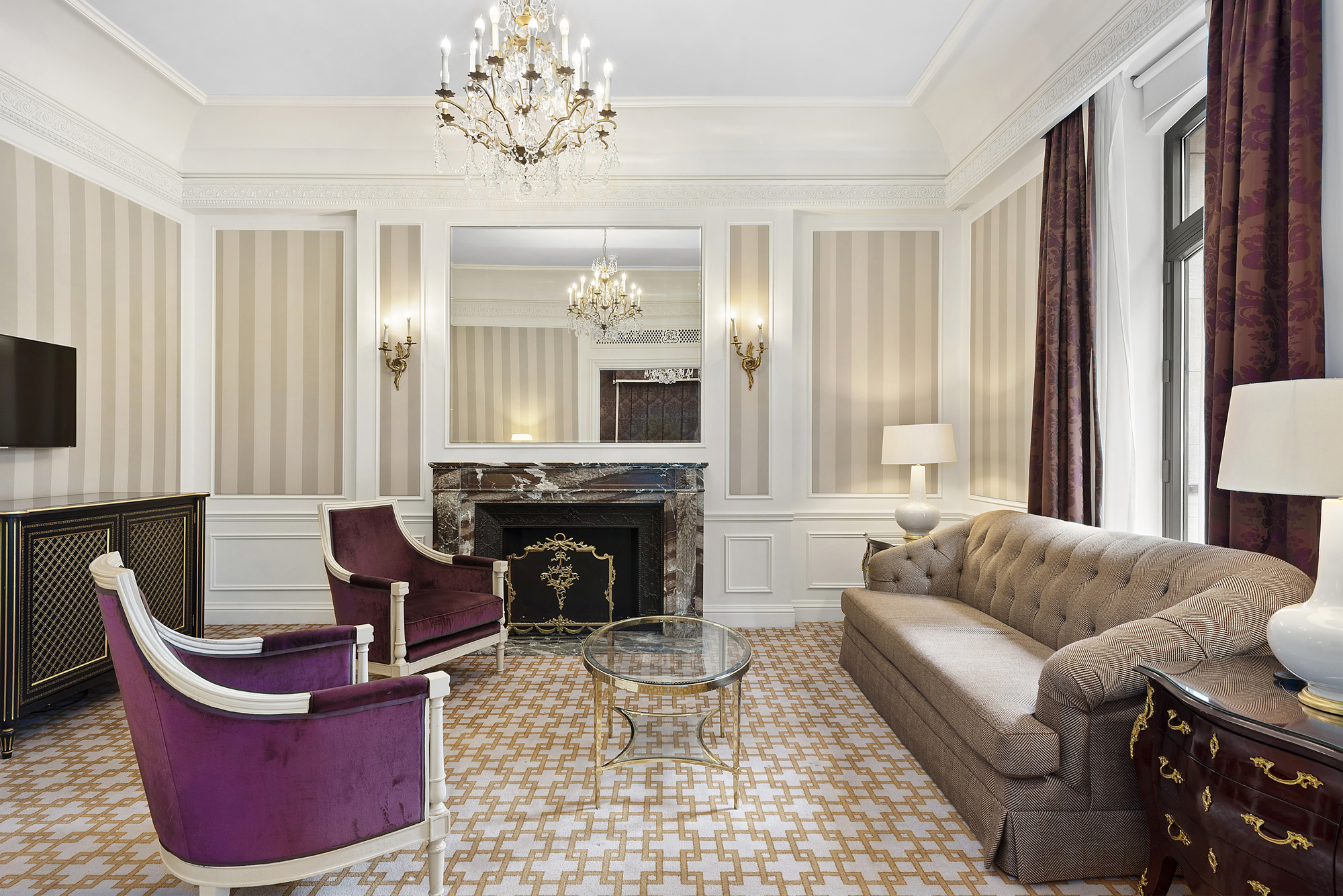 a living room with furniture a large window and a fireplace