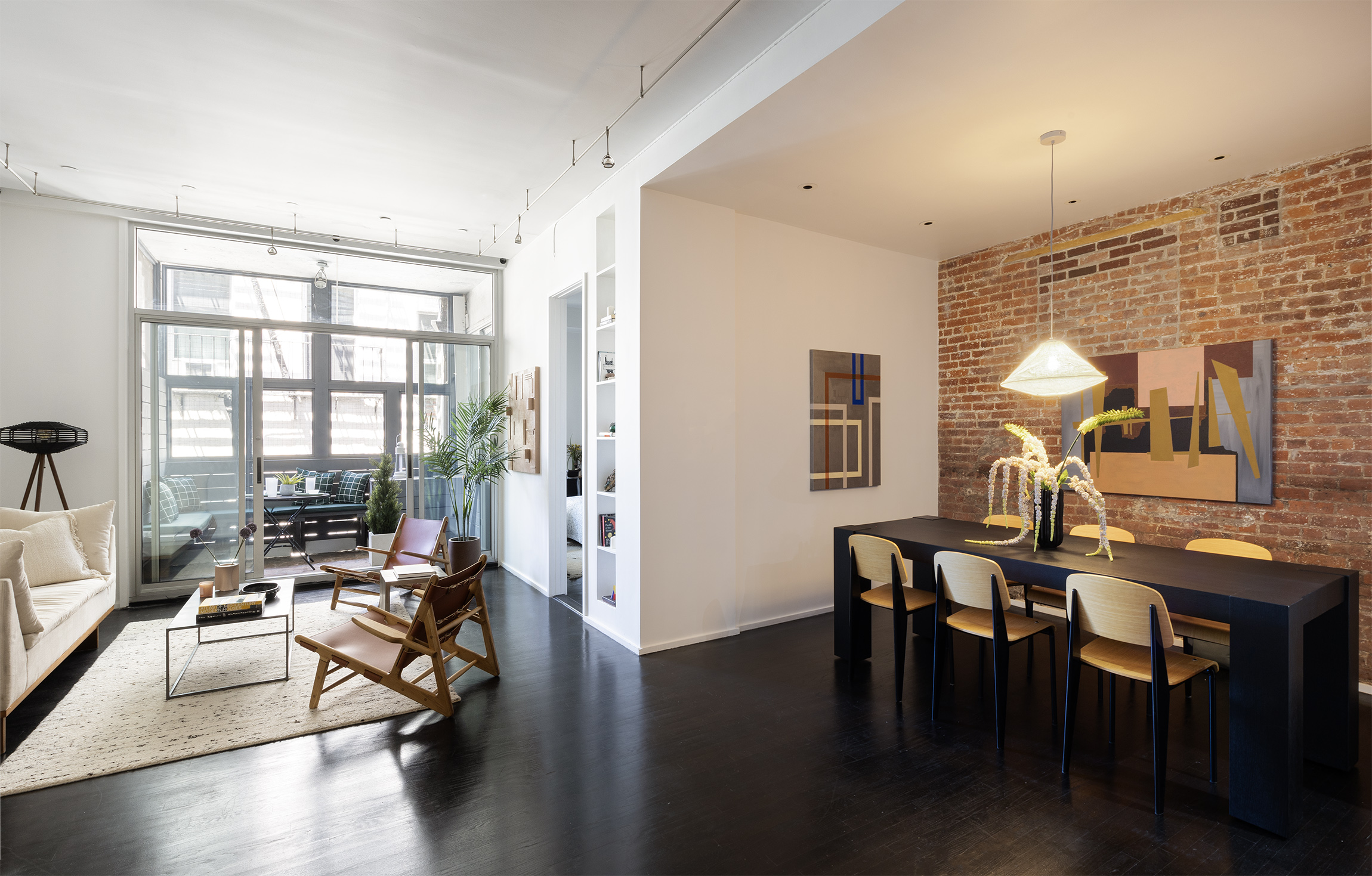 a living room with furniture a wooden floor and a large window