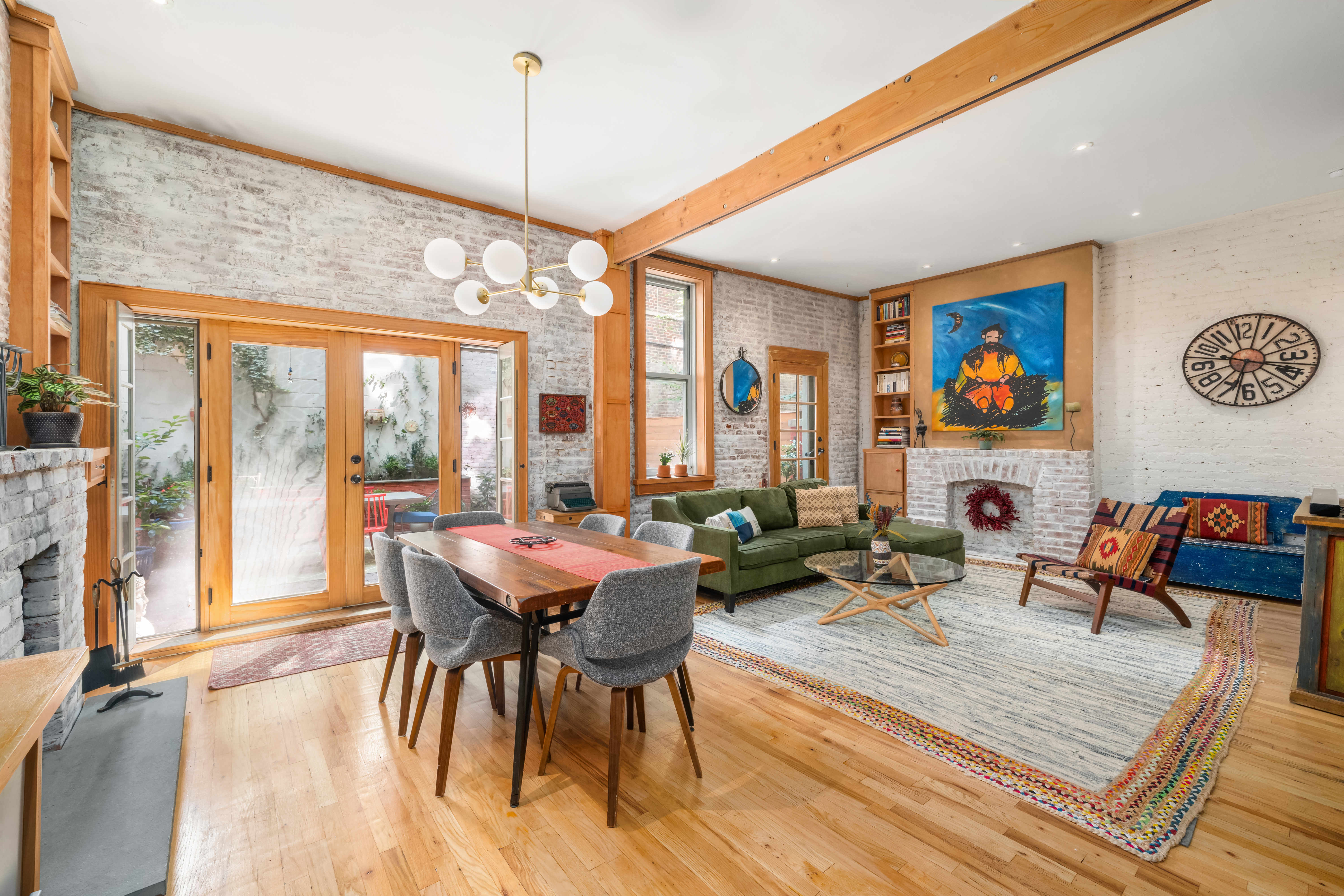 a living room with furniture a rug and a floor to ceiling window