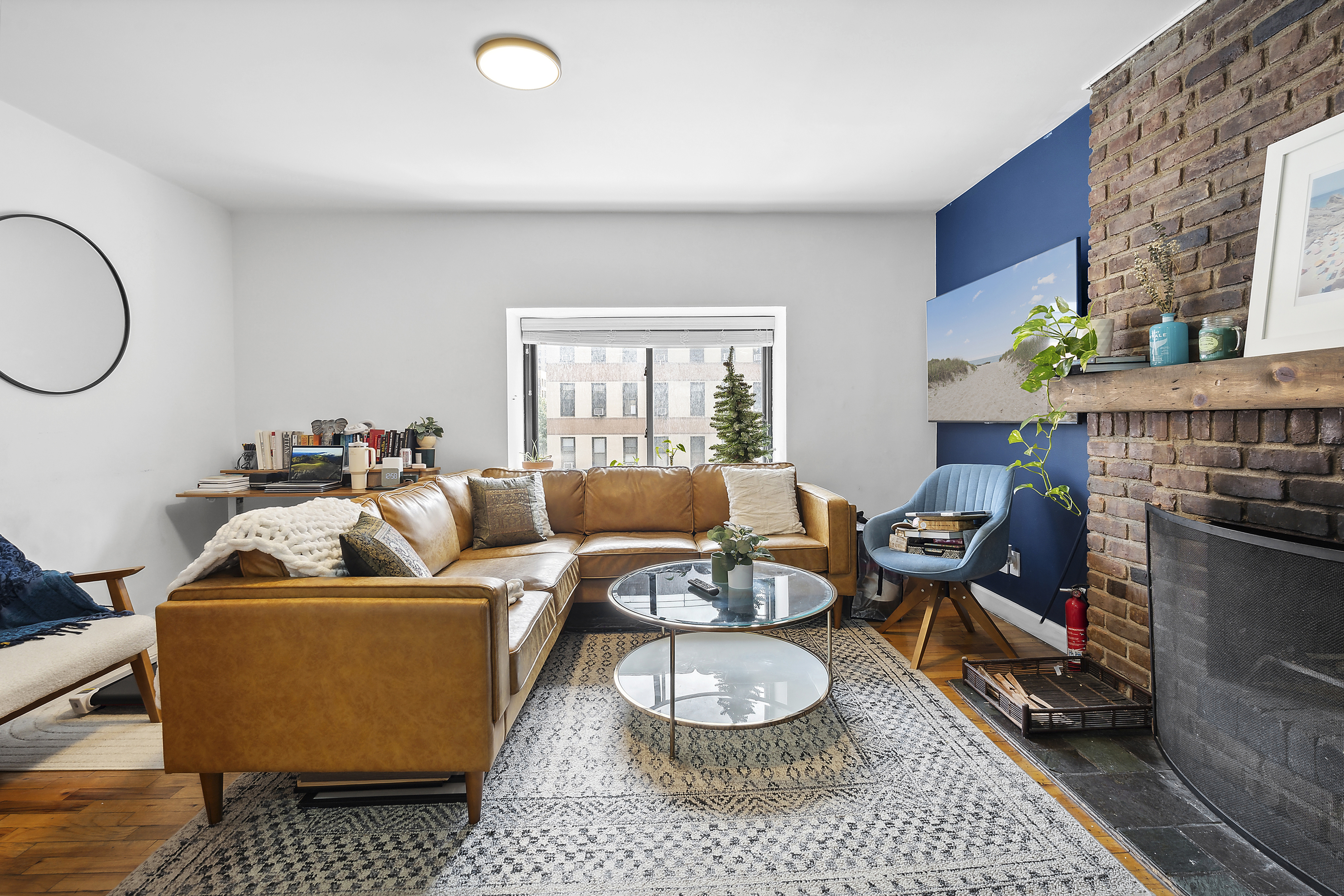 a living room with furniture a rug and a window