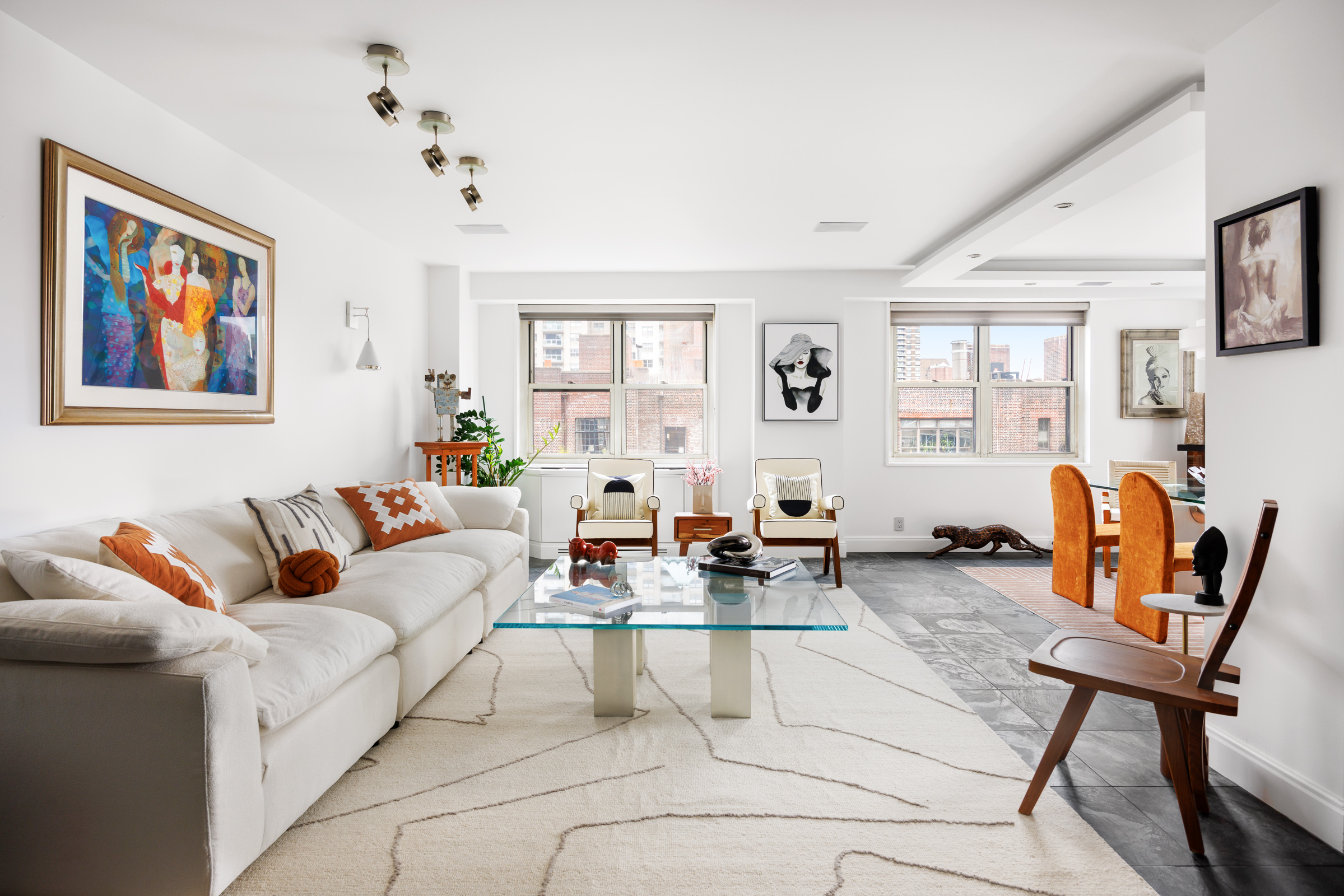 a living room with furniture a flat screen tv and a window