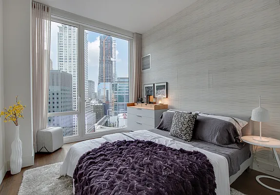 a bedroom with a bed and glass window