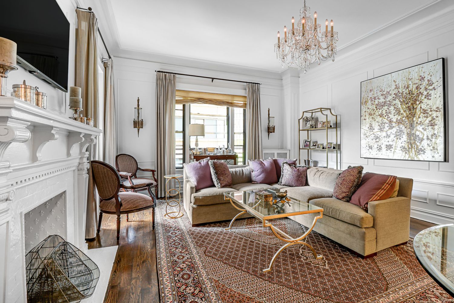 a living room with furniture a chandelier and a window