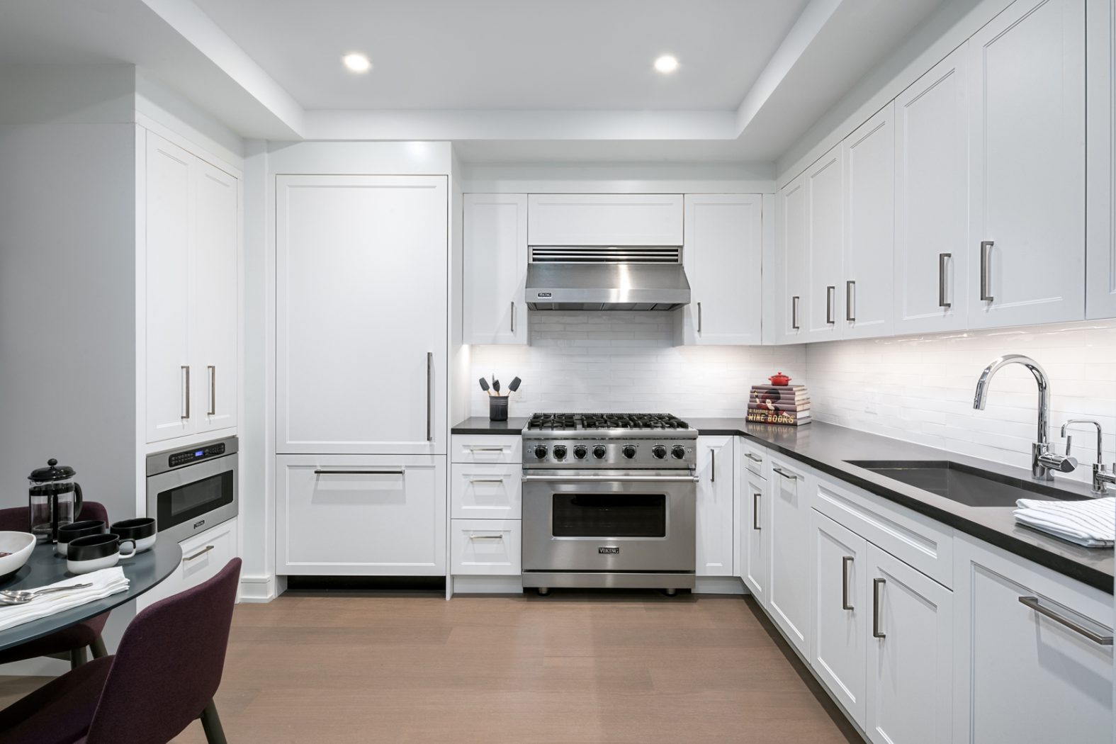 a kitchen with stainless steel appliances granite countertop a sink stove and cabinets