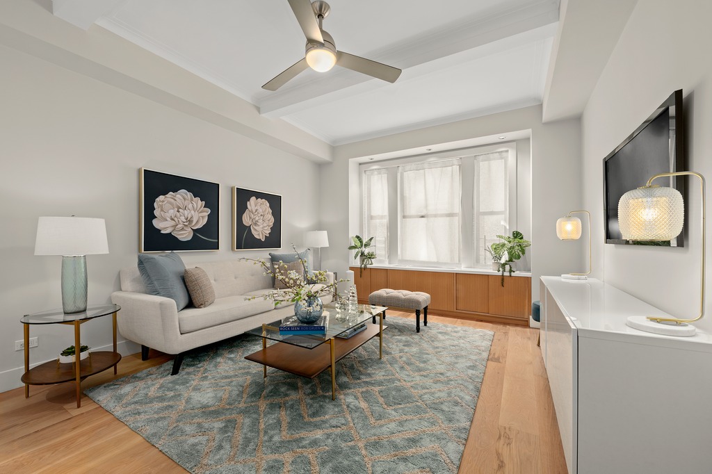 a living room with furniture and a wooden floor