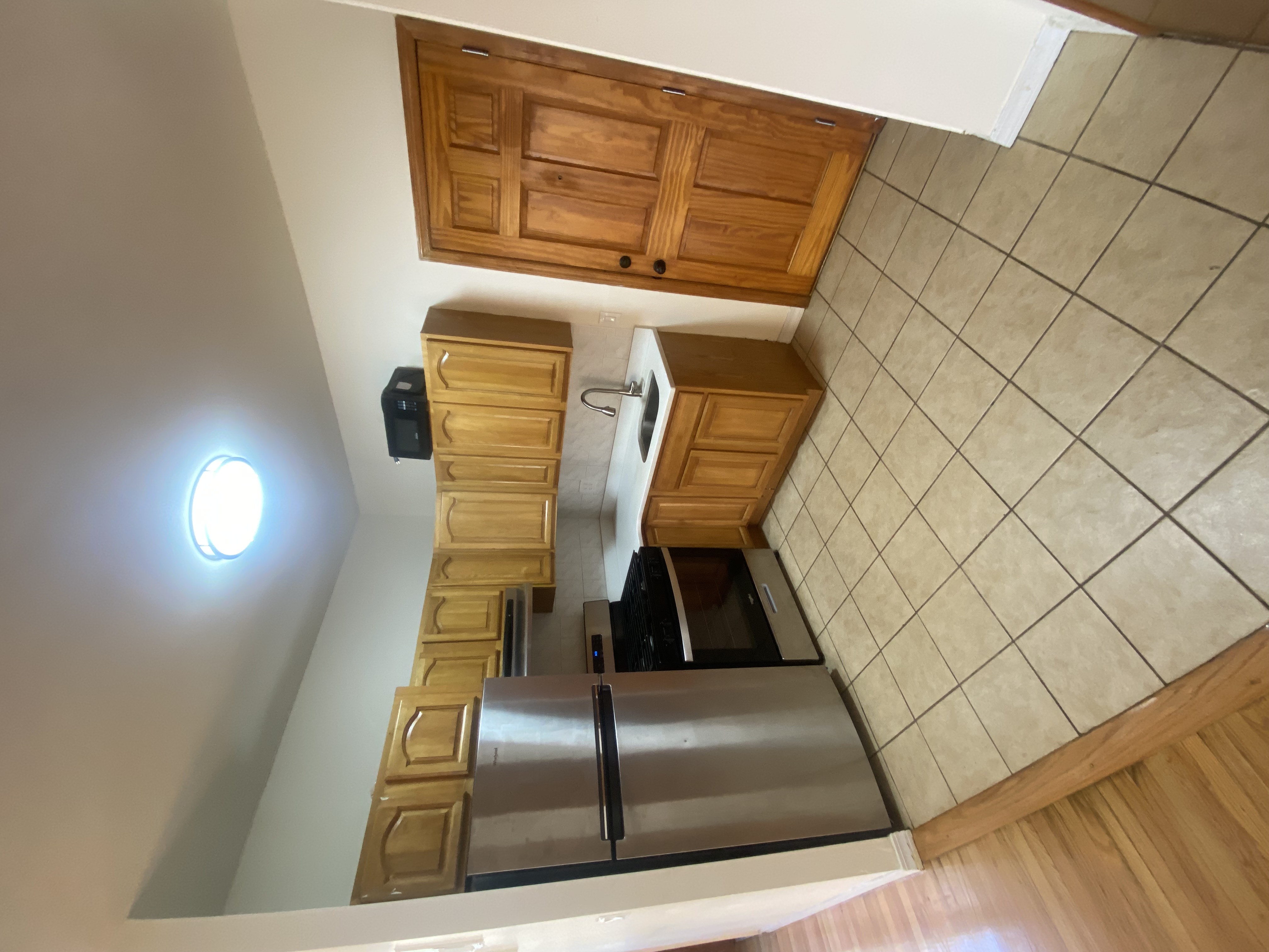 a kitchen with stainless steel appliances a refrigerator and a stove top oven