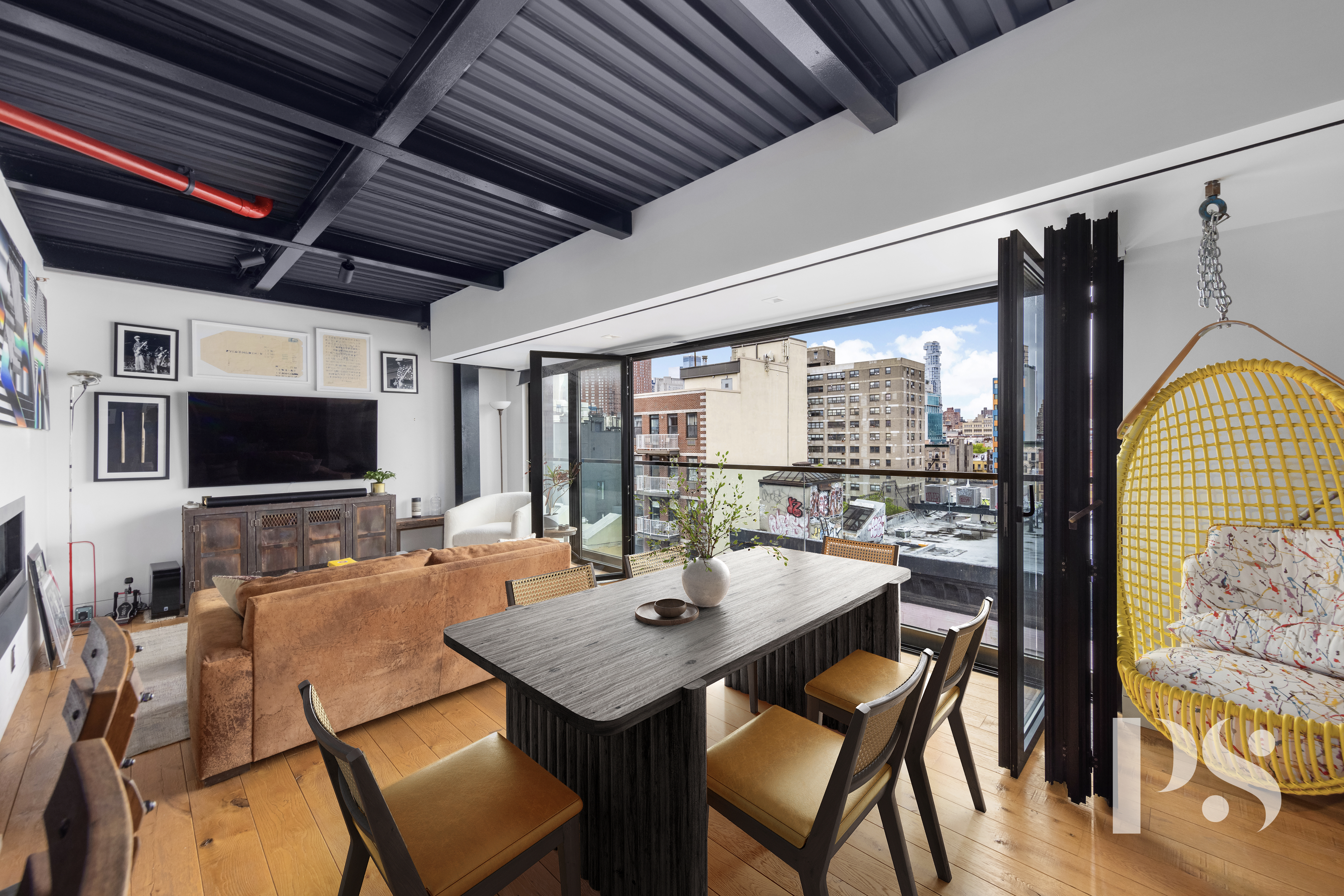 a dining room with furniture a flat screen tv and a floor to ceiling window