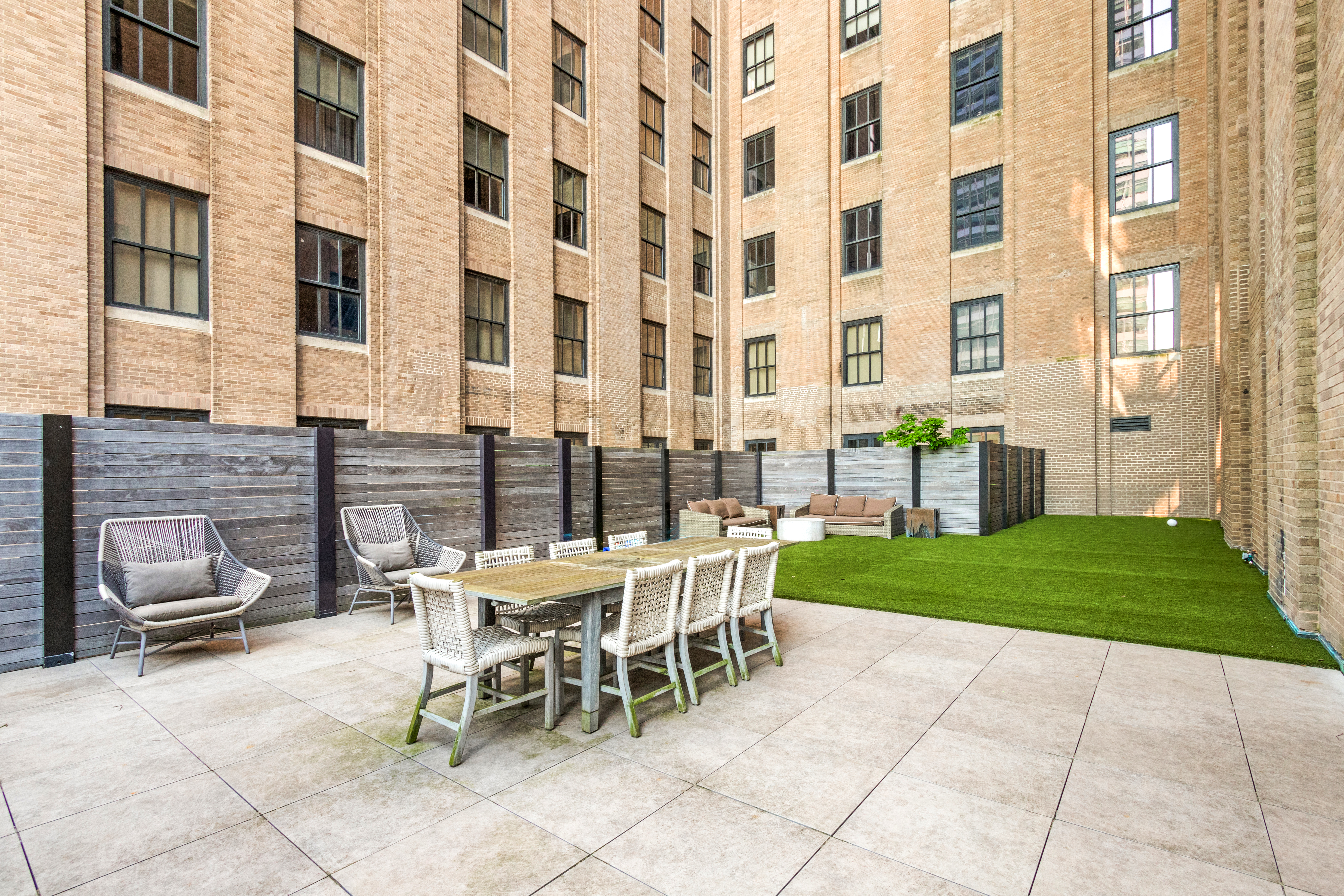 a view of a patio with a table and chairs and potted plants