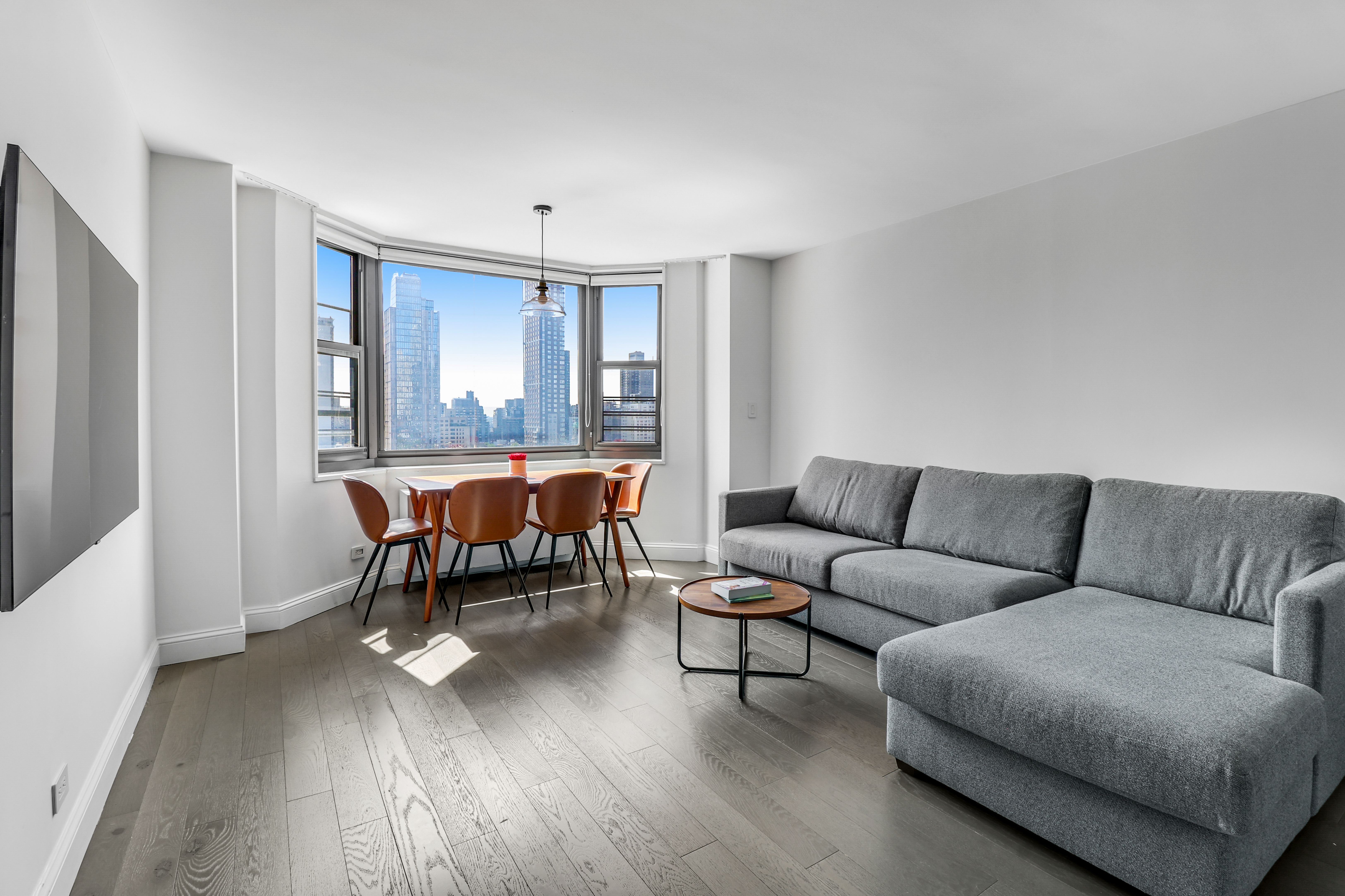 a living room with furniture and a wooden floor