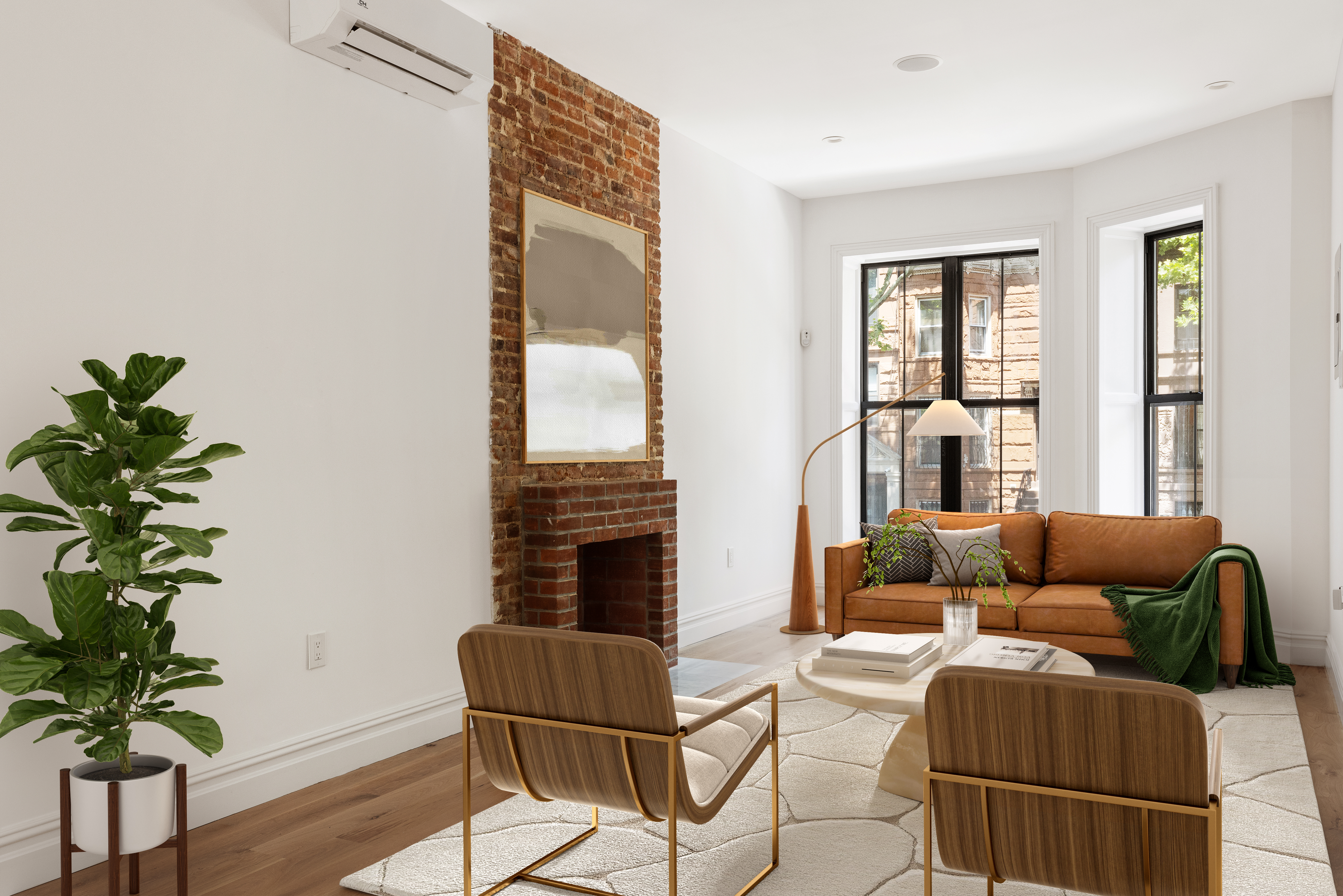 a living room with furniture and a potted plant