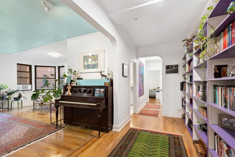 a living room with furniture and a book shelf