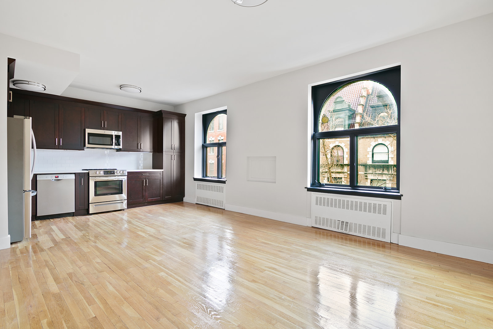 a view of a livingroom with an entryway and kitchen