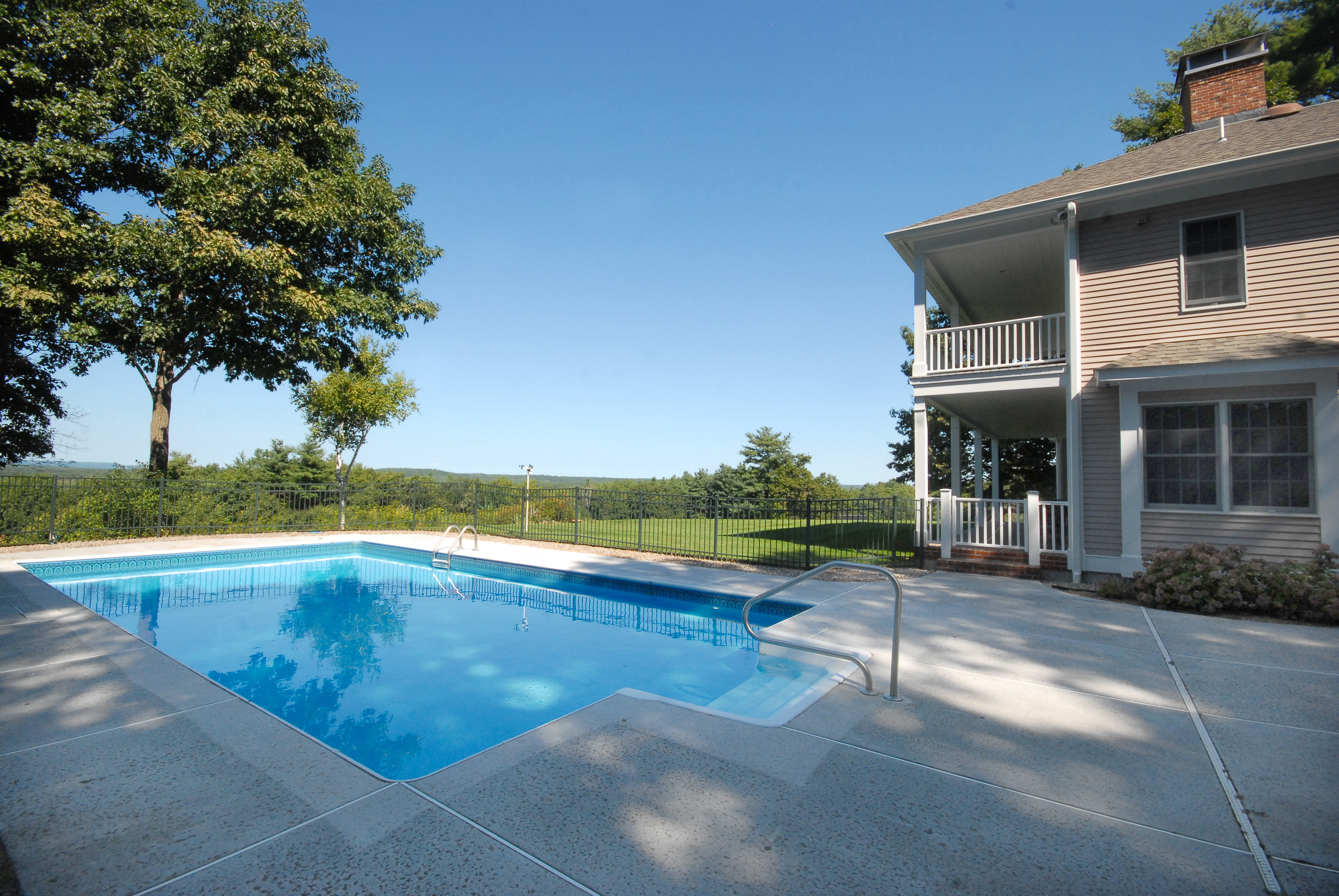 a view of a house with swimming pool and a yard