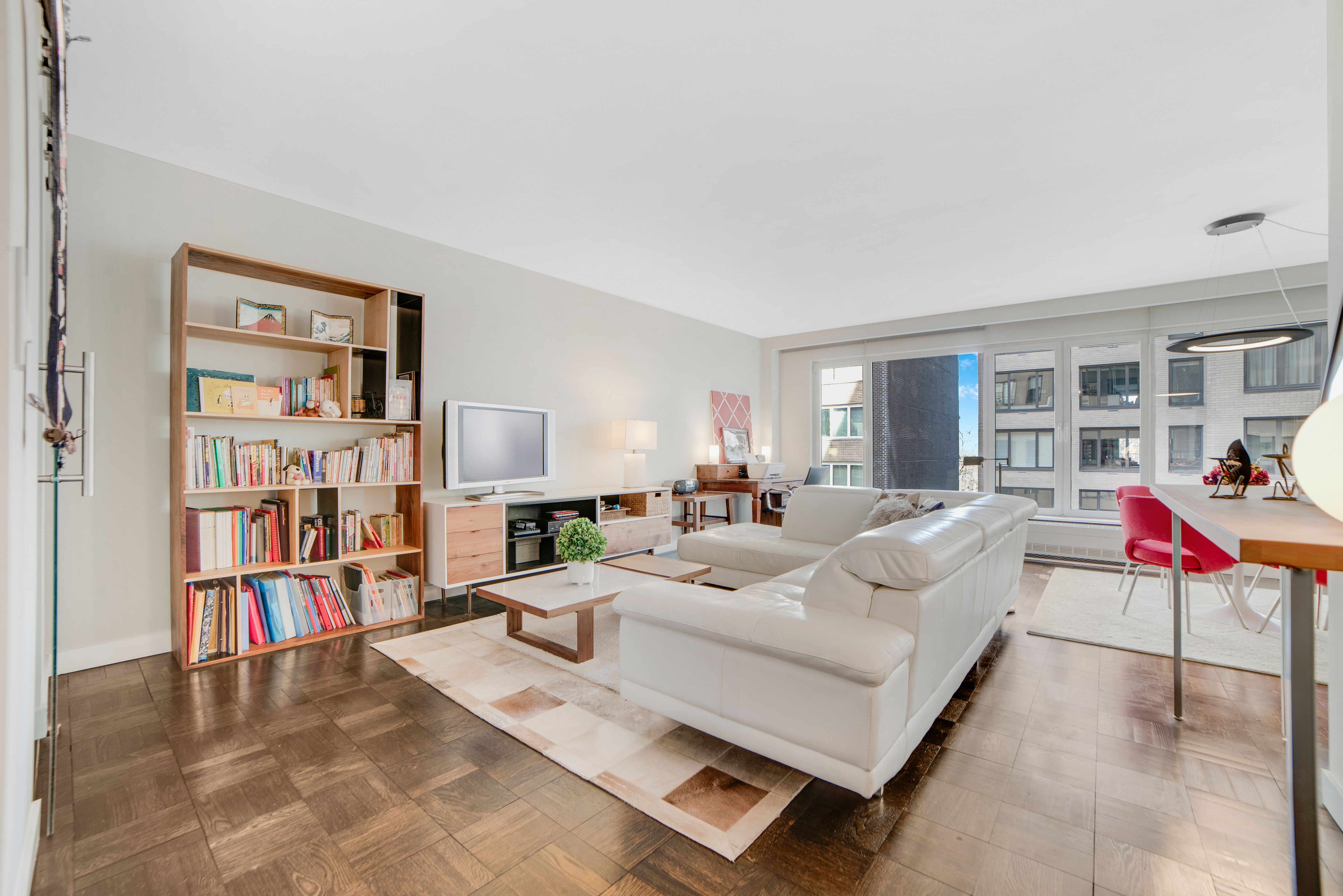 a living room with furniture and a book shelf