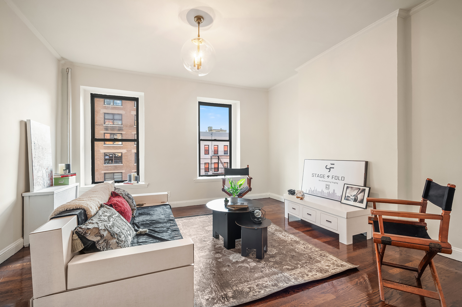 a living room with furniture and a potted plant