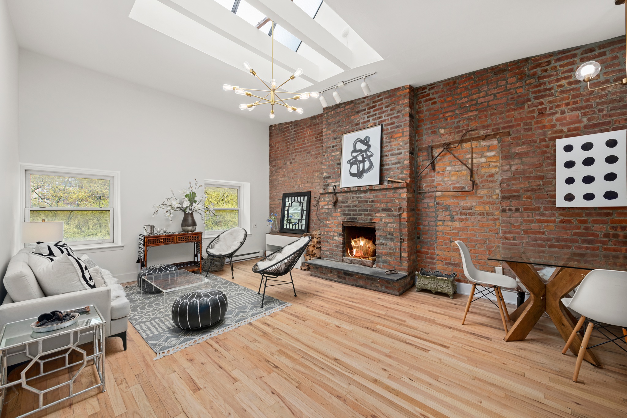 a living room with furniture a fireplace and wooden floor