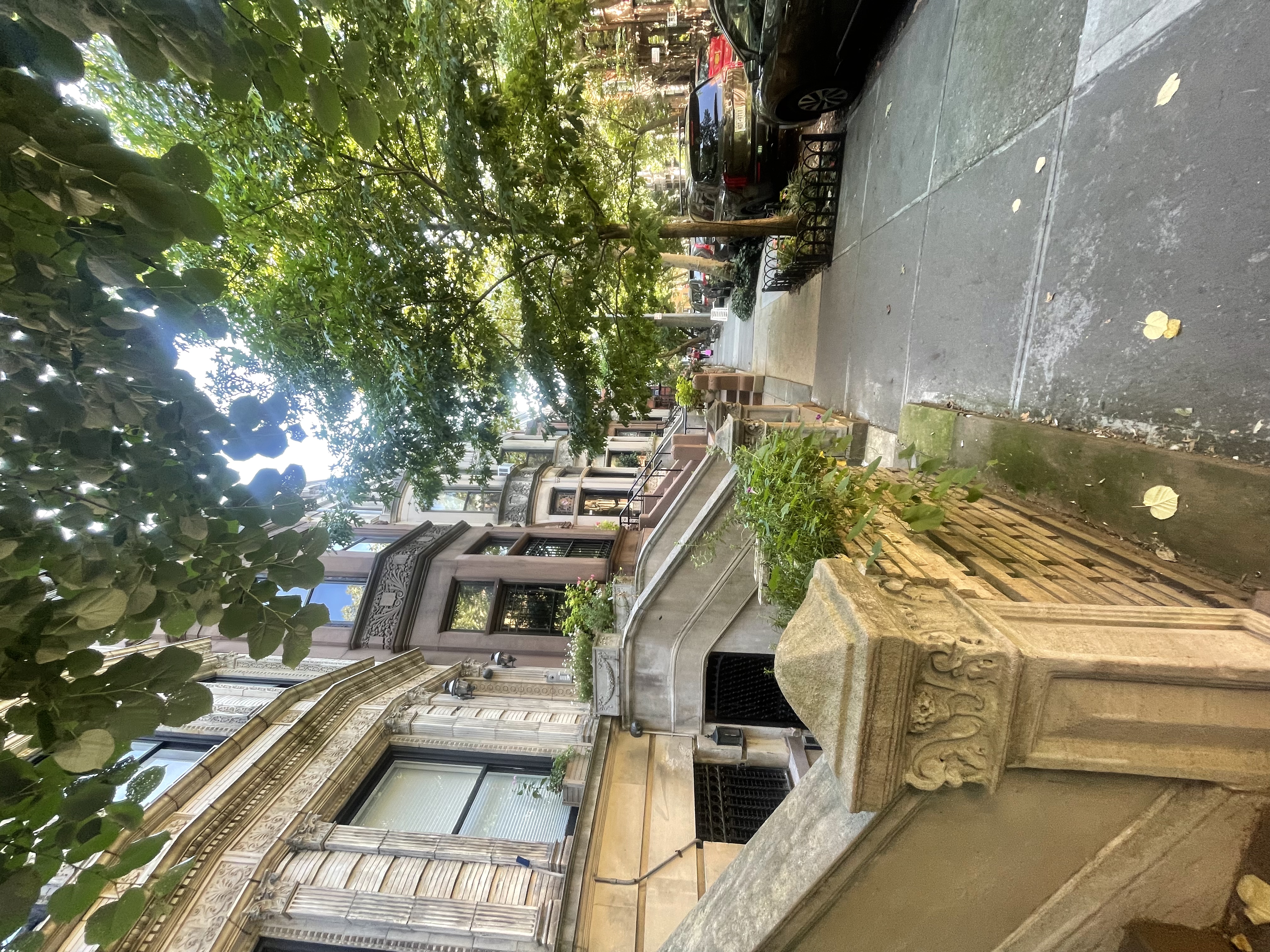 a view of a street that has couple of cars parked on the road