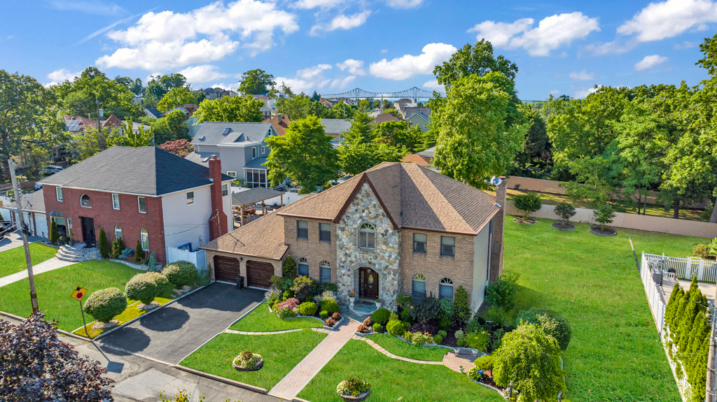 a aerial view of a house with a big yard plants and large trees