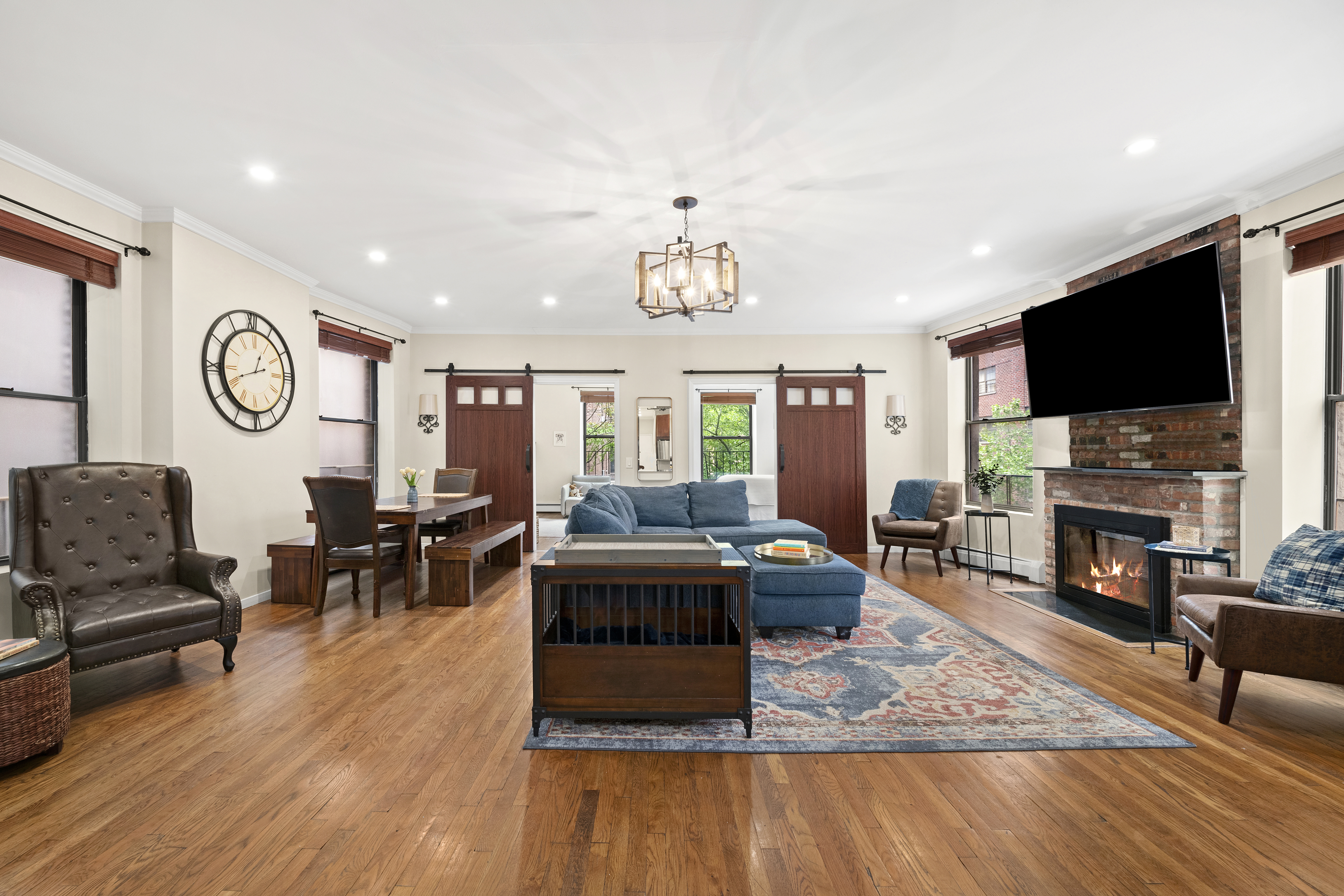 a living room with furniture a fireplace and a flat screen tv