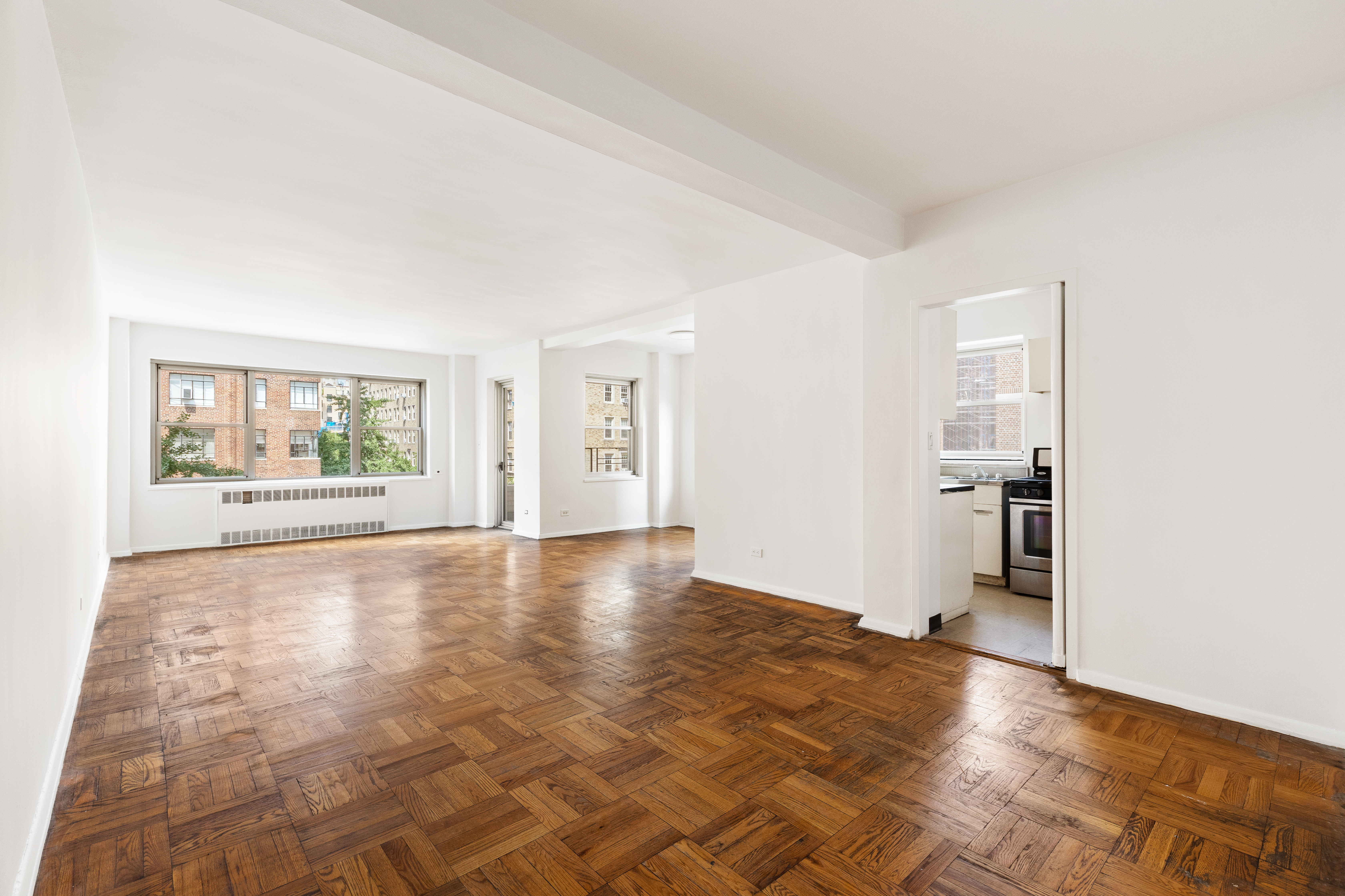 an empty room with windows and entrance